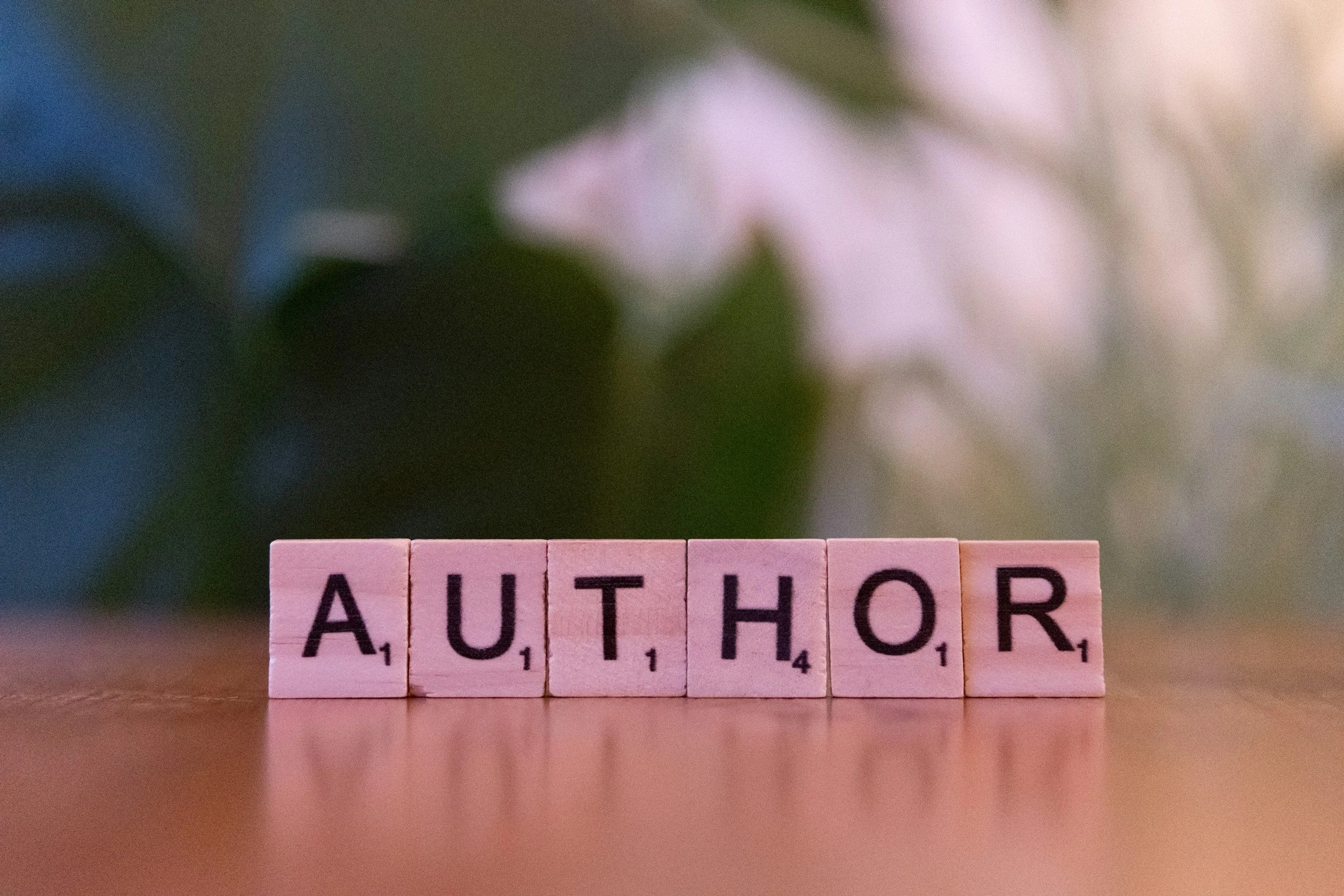 author on desk writing book