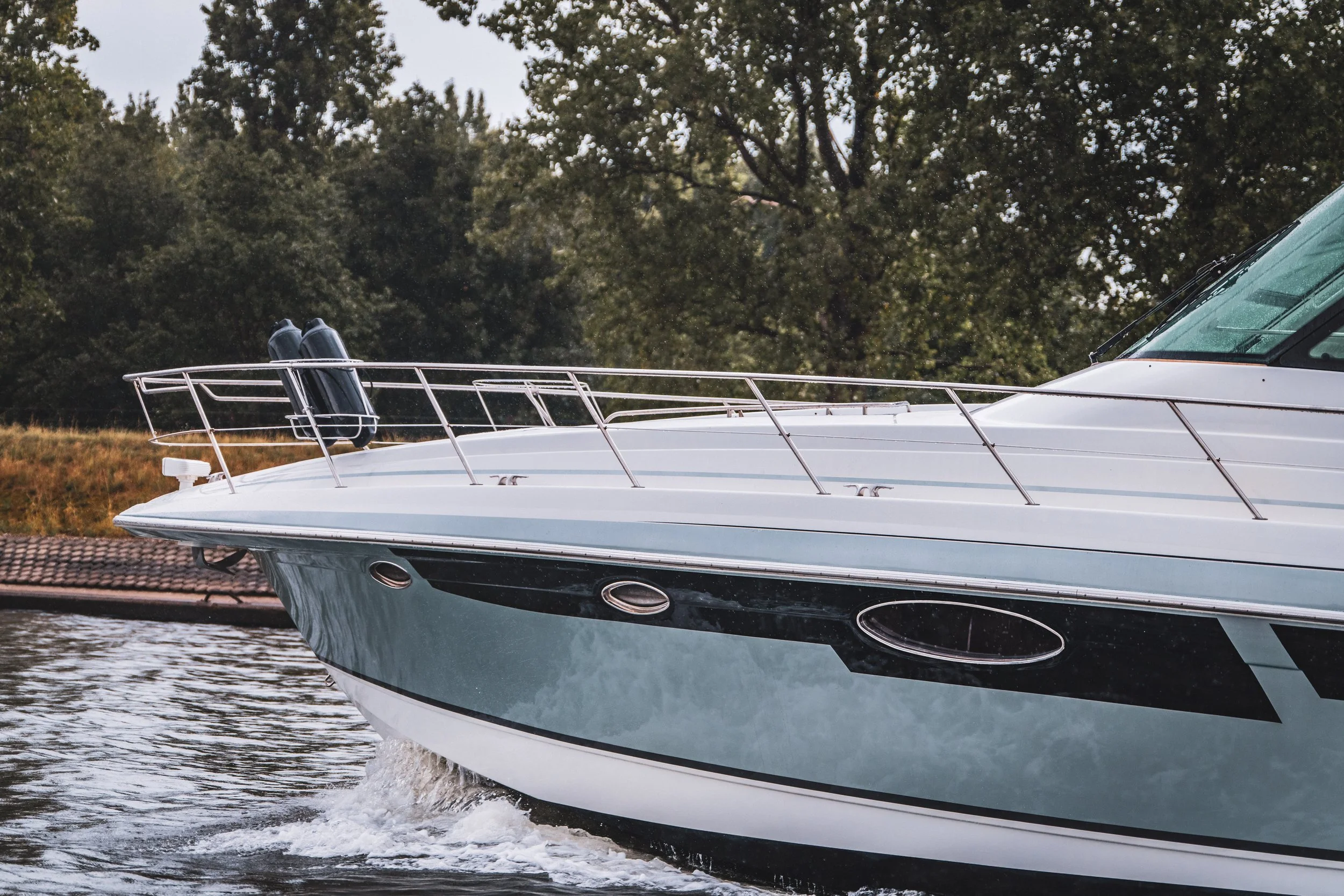 Luxury motor yacht cruising on a lake at sunset