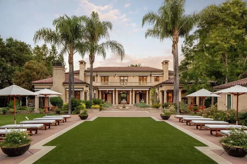 Representative luxury estate home in Atherton, California, featuring a flat lot, landscaped grounds, and resort-style outdoor spaces.