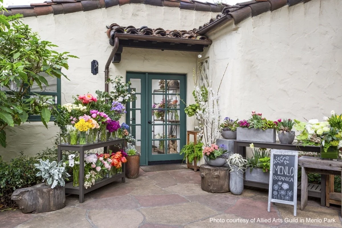 Garden courtyard and floral displays at the Allied Arts Guild in Menlo Park, showcasing California lifestyle.