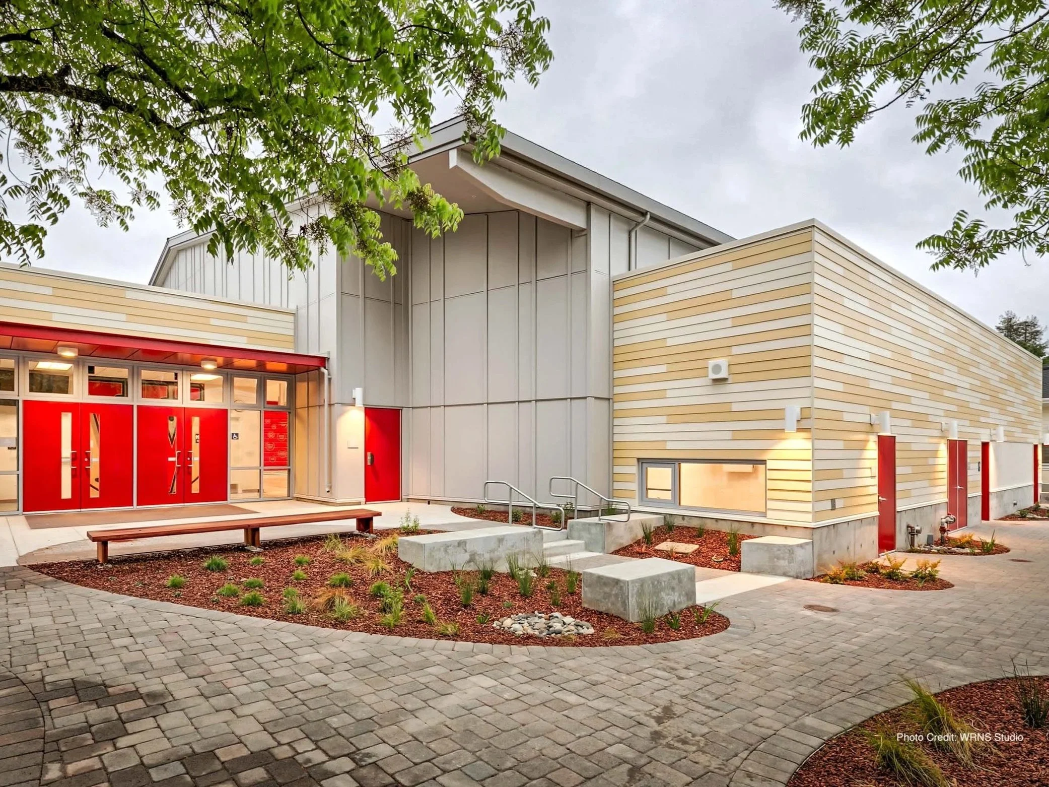 Woodside Elementary School building in Woodside, California, featuring a modern exterior with light-colored siding and red architectural accents.