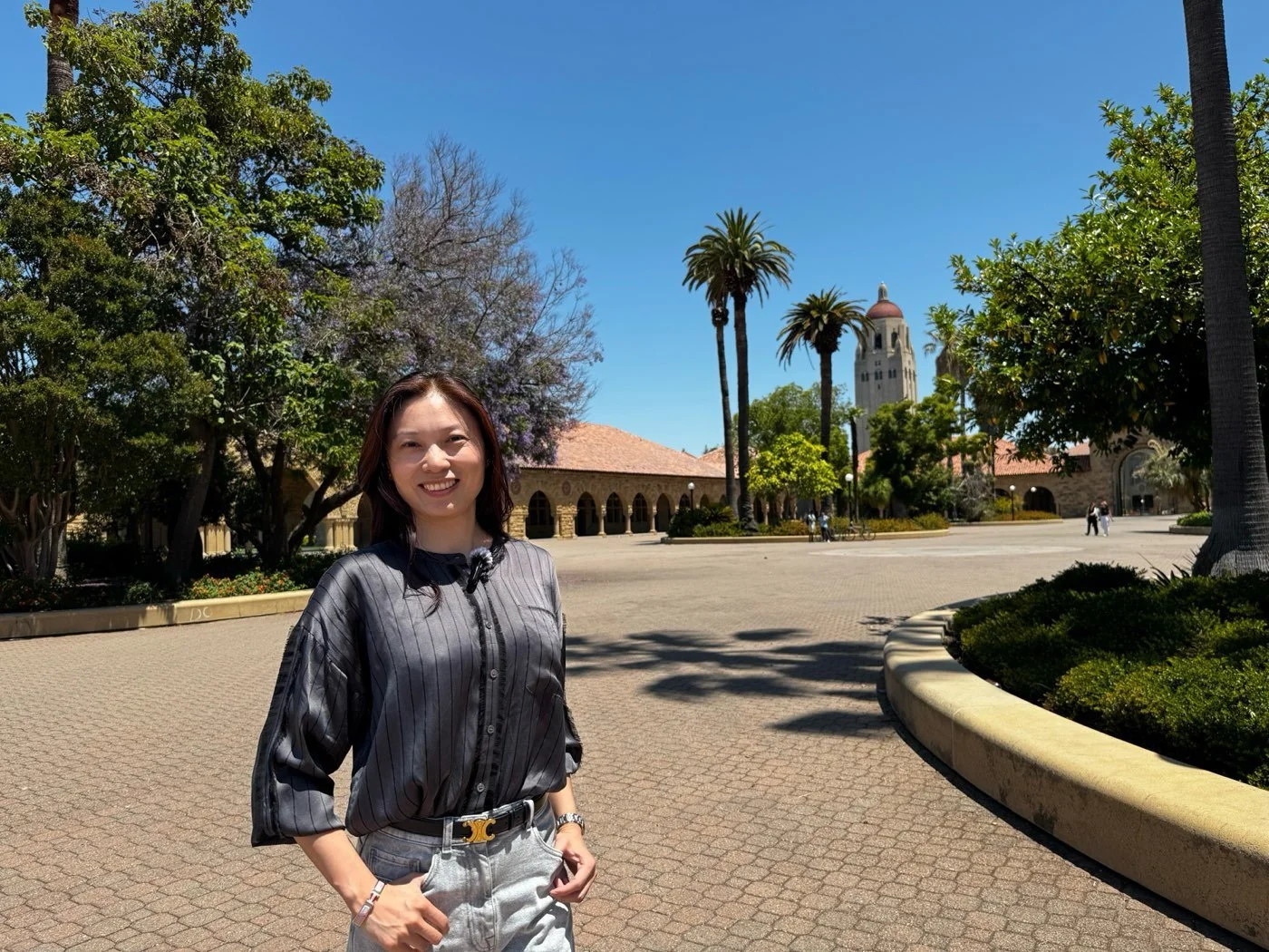 Fang Yuan, Golden Gate Sotheby's International Realty, at Stanford University with Hoover Tower behind her