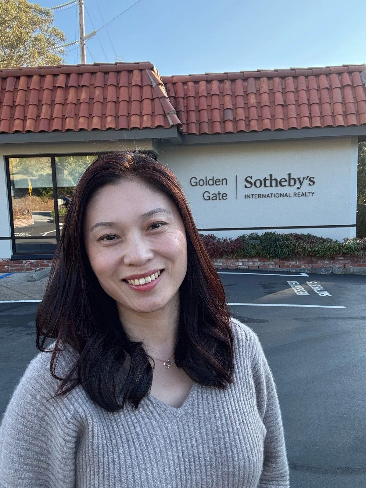 Fang Yuan outside the Golden Gate Sotheby's International Realty office in Woodside