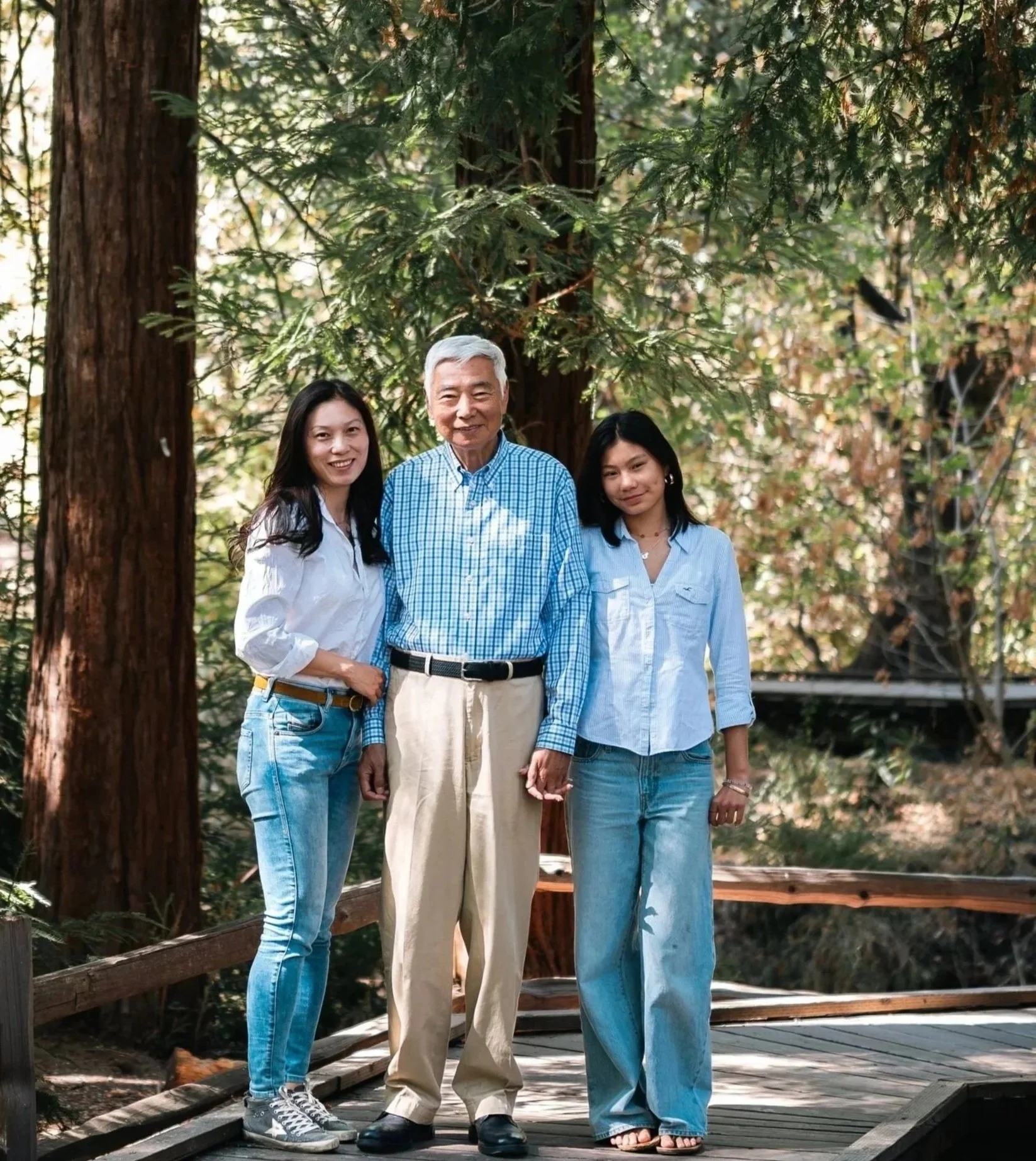 Fang Yuan with her father and daughter at Los Altos Redwood Grove Nature Preserve, reflecting family values of service, integrity, and trust that shape her approach to Silicon Valley real estate.