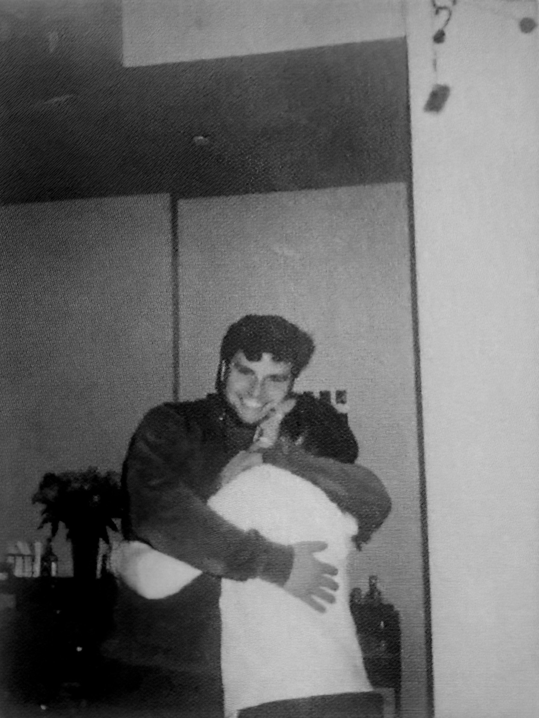 Drew smiling and hugging Sav while posing for a picture in her college apartment.