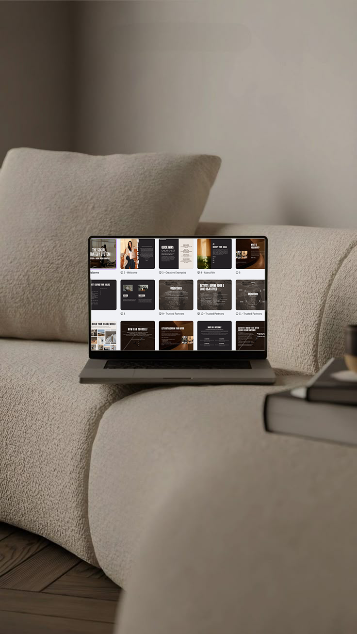 Laptop on a beige couch displaying presentation slides or a digital deck