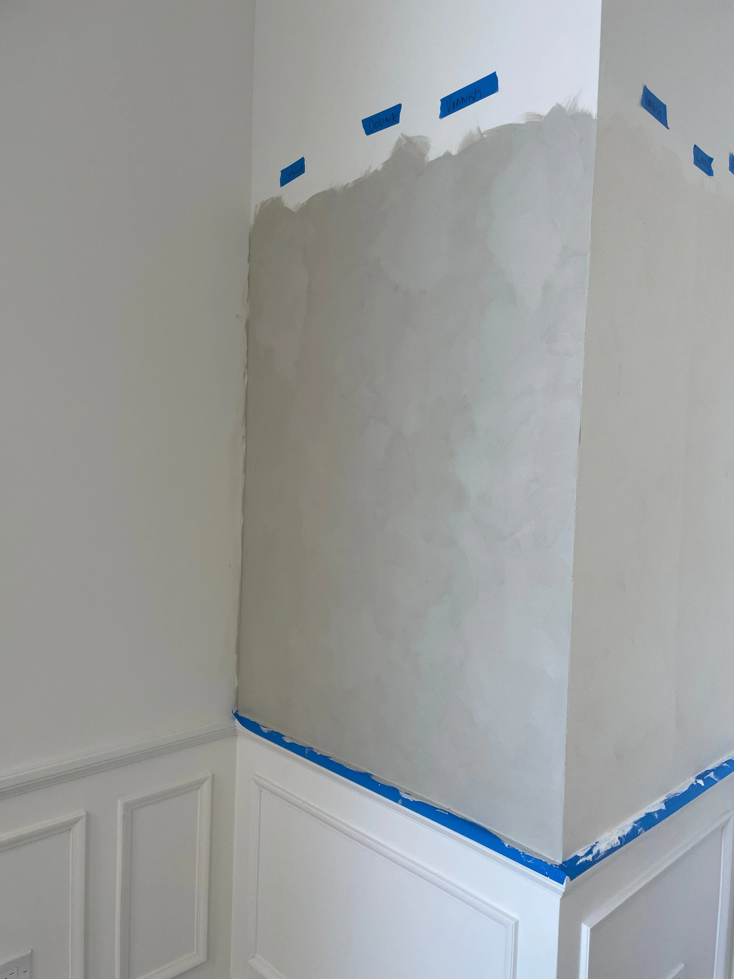 Sample wall with hand-applied plaster finish, illustrating subtle tonal variation and texture achieved through artisanal craftsmanship