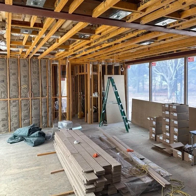 Construction framing, insulation, and material selections during home renovation that influence interior designer fees and overall project cost