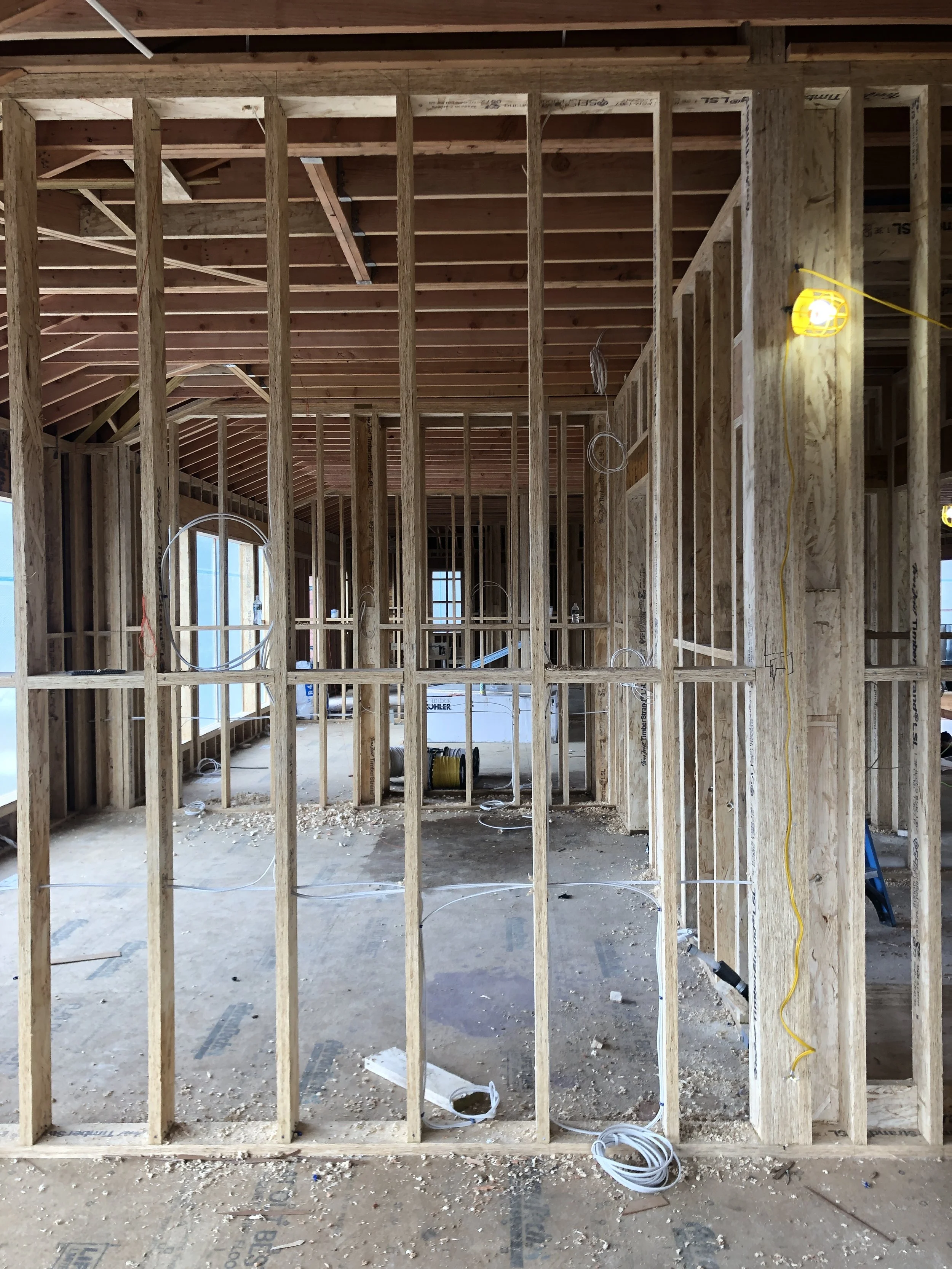 New Build house under construction showing studs and electrical from Studio Ness