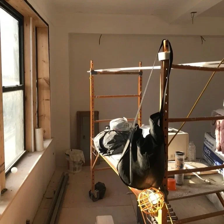 Interior designer conducting on-site project management during home renovation build-out illustrating what is included in interior designer cost and construction oversight fees