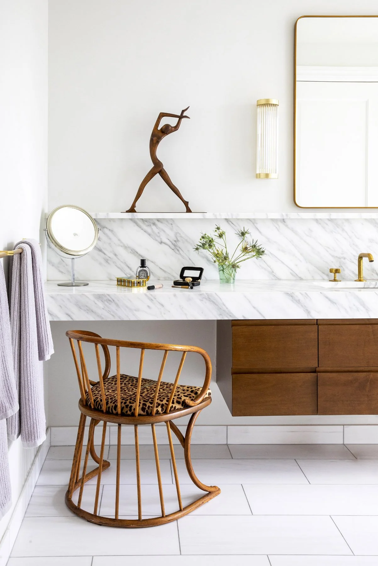 A custom floating vanity spanning the full length of the Upper West Side Renovation bath, bringing clarity and architecture to the room. Paired with a makeup vanity, it balances function and refinement, creating a tailored, personal rhythm.