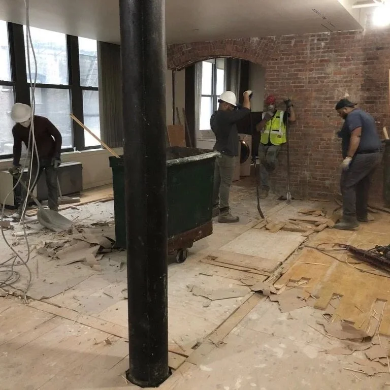 Demolition phase of luxury loft renovation showing contractor labor and construction work that impacts how much an interior designer costs