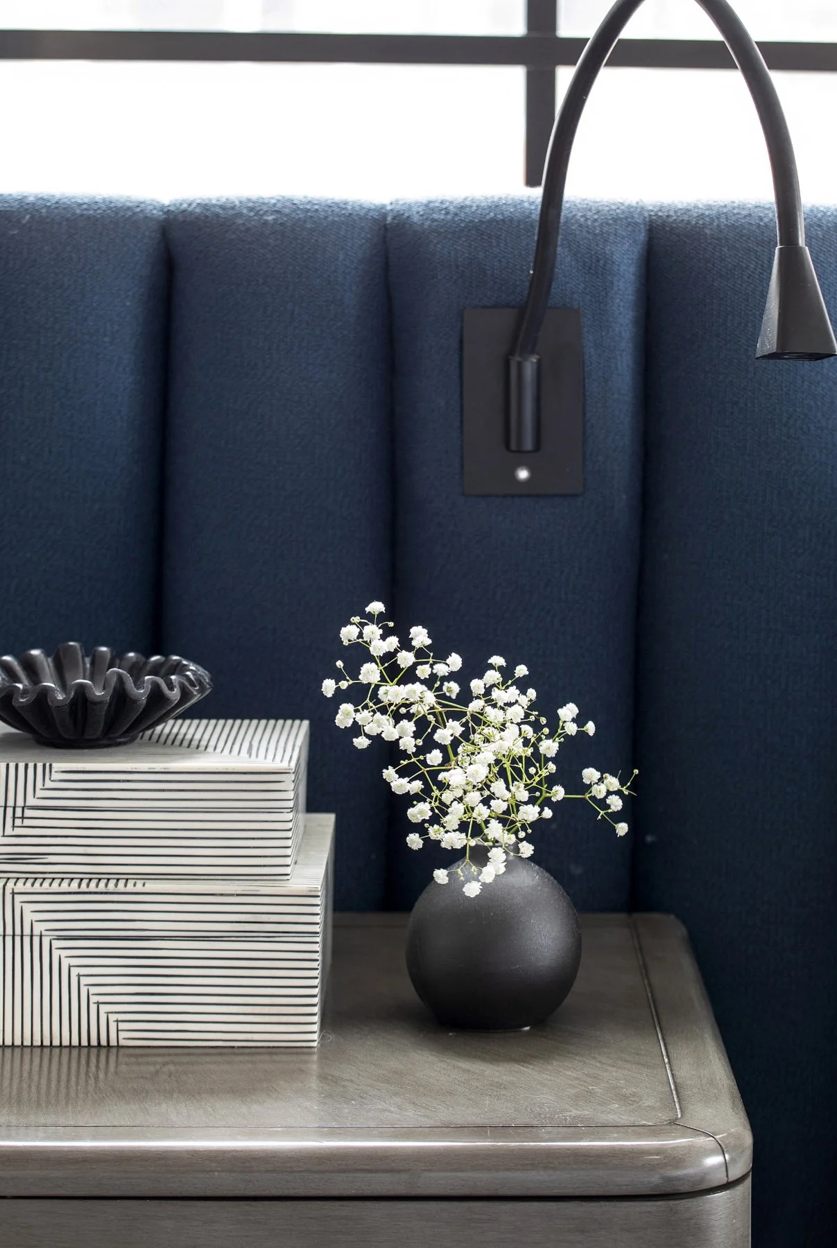 A fully custom, wall-to-wall bed set with integrated lighting and power for a quiet, hotel-level feel. Designed to let the curtains sweep behind it, the piece creates a seamless backdrop and anchors the Hudson Yards Penthouse bedroom.