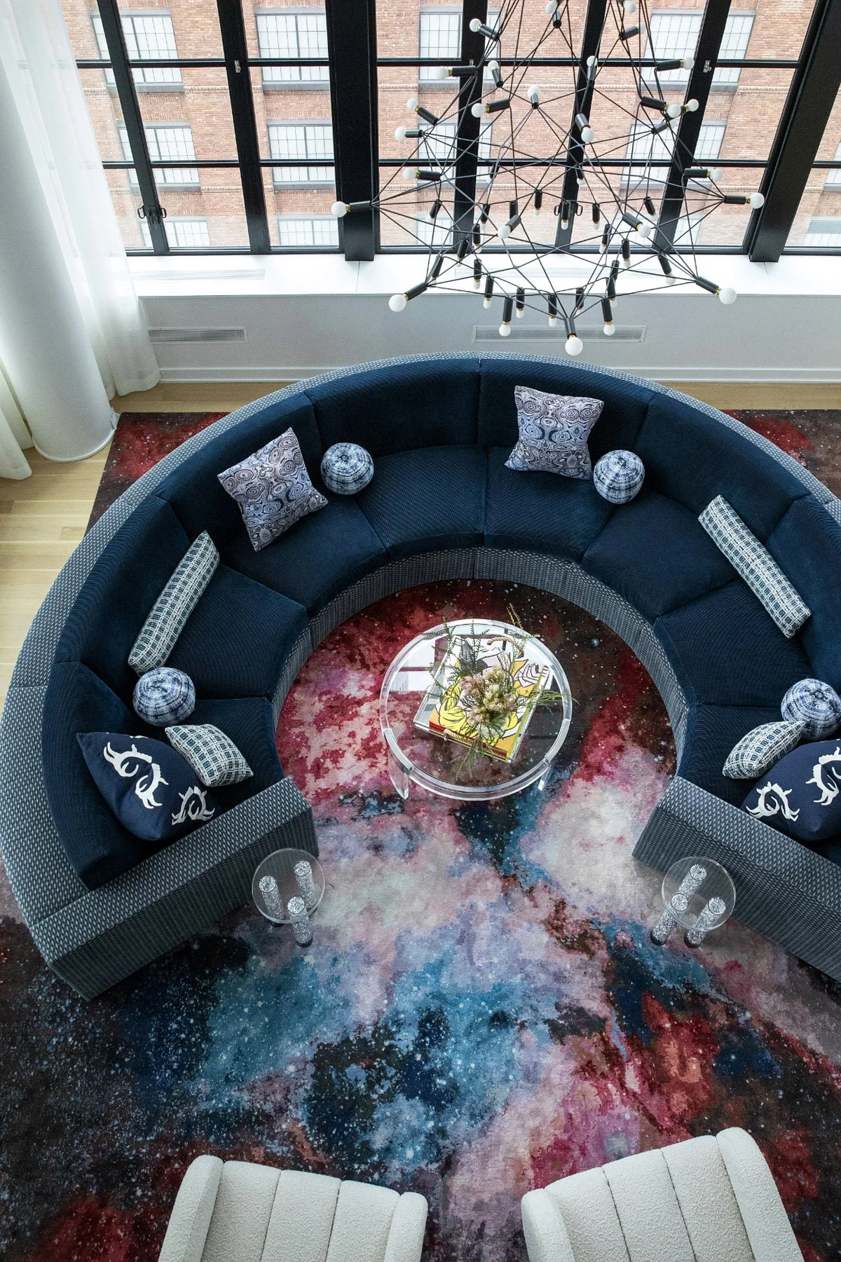 A custom curved sofa shaped to hold the room and frame the skyline beyond. Its sculpted back creates a gentle ledge to lean into, inviting anyone to pause and take in the sweeping Hudson Yards Penthouse views.