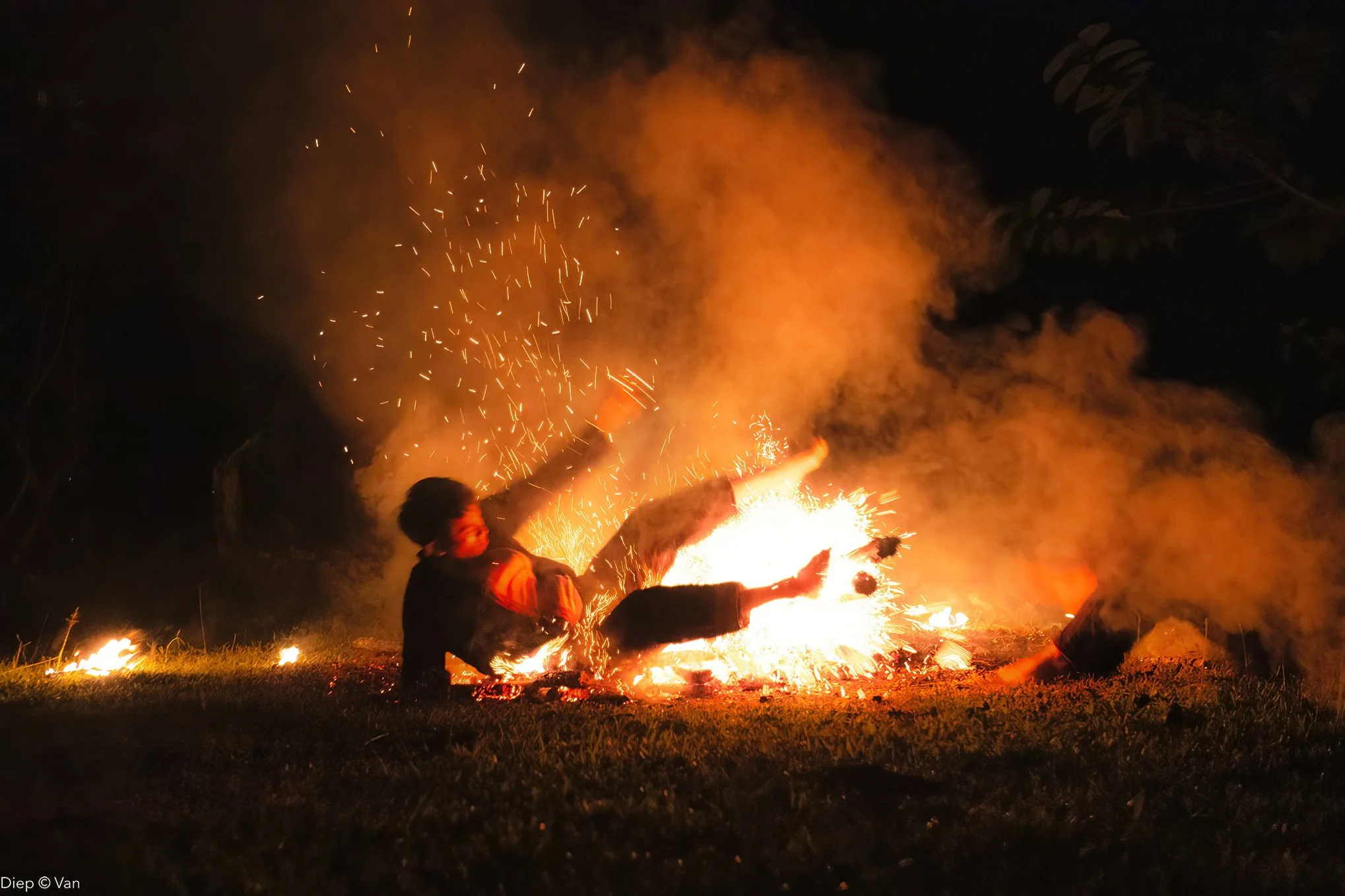 Person falling onto the ground during a firework explosion at night