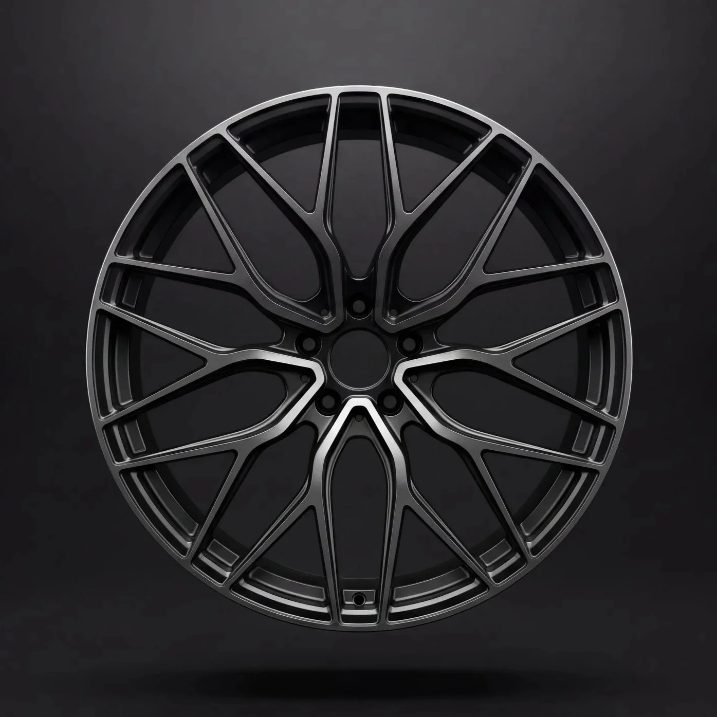 A black multi-spoke car wheel rim against a dark background.
