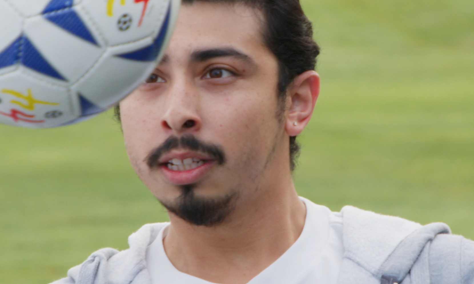 Soccer player keeps his eyes on the ball