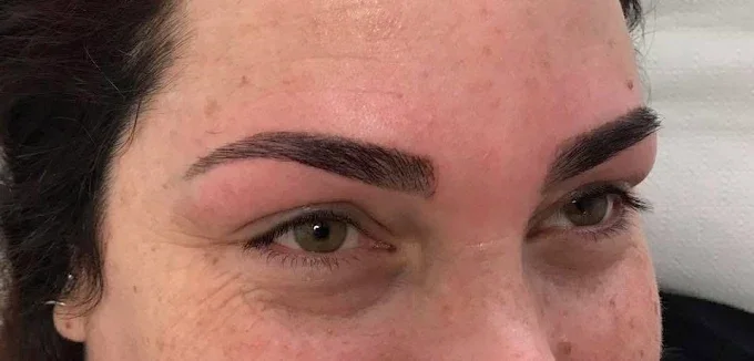 Close-up of a woman's face focusing on her eyes and eyebrows.