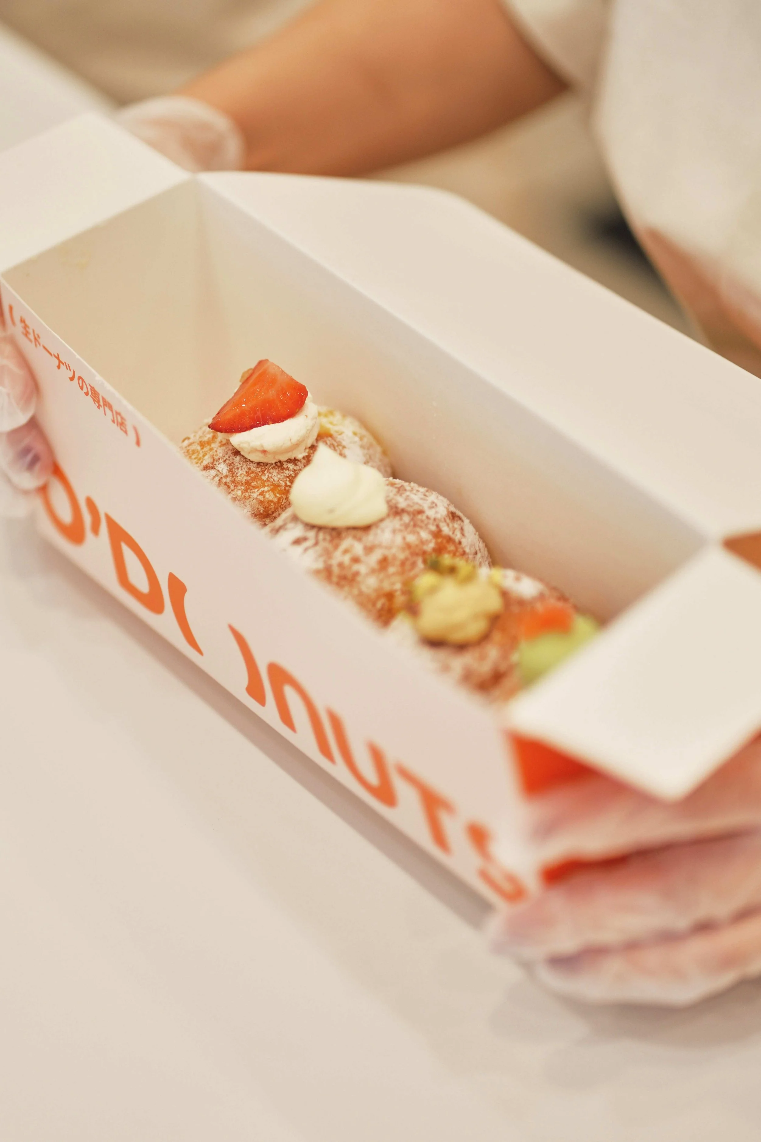 Assorted nama donuts with cream and toppings in box, fresh donuts Sydney