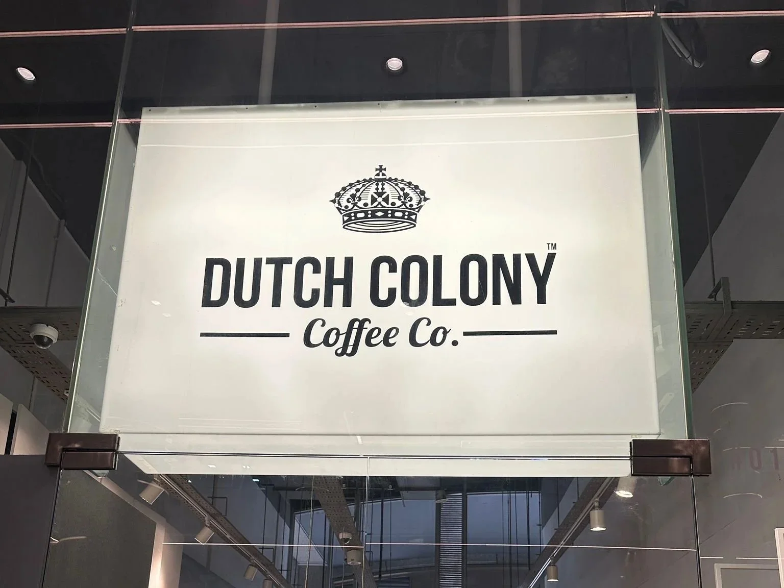 Sign for Dutch Colony Coffee Co. with a crown graphic at the top.