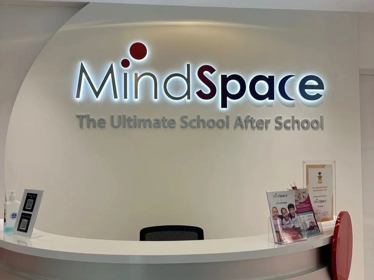 Reception desk with a sign that reads "MindSpace The Ultimate School After School" and informational brochures.