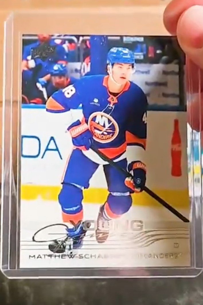 Hockey trading card featuring a player in a New York Islanders uniform with the number 8, on the ice during a game.