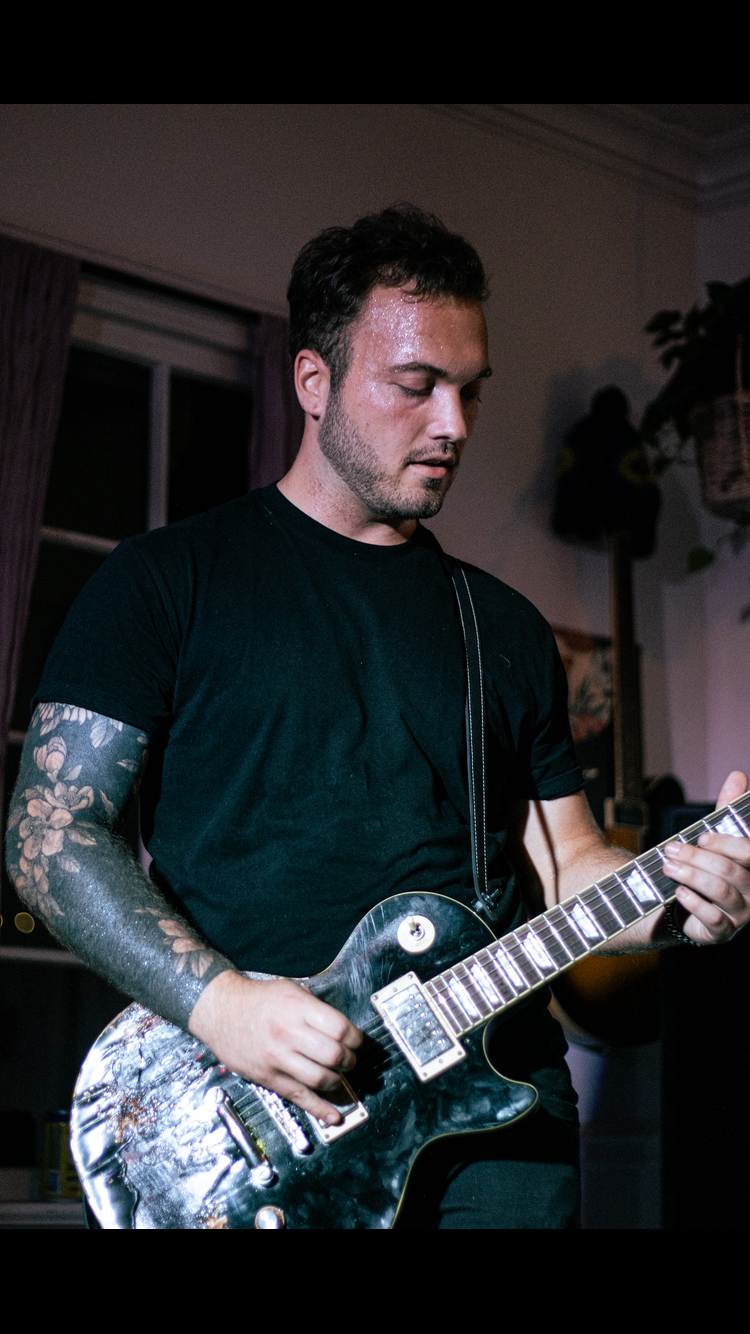 Jacob Diddens playing his burnt, black Epiphone Les Paul in 2025 at The Twisted Tea Garden in Madison, Tennessee.