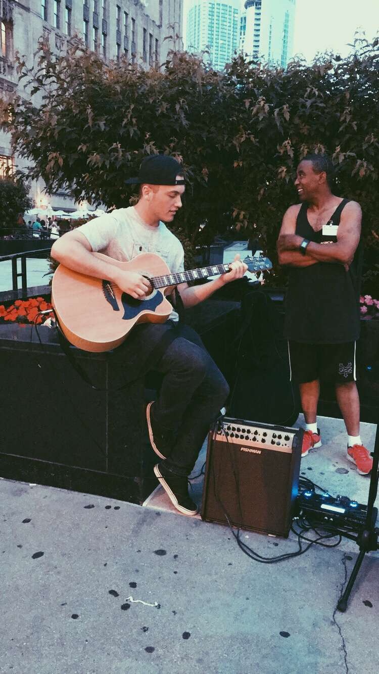 Jacob Diddens playing his friend's guitar in Chicago in the late 2010's.