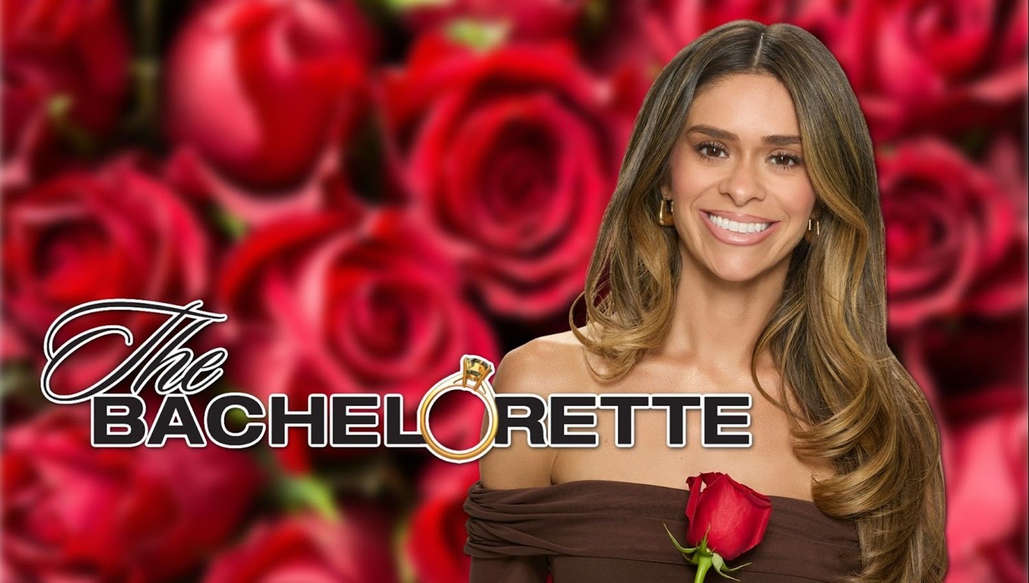A woman with long, wavy brown hair, smiling, wearing a brown off-the-shoulder top, holding a single red rose, in front of a background of red roses, with the logo 'The Bachelorette' in the foreground.