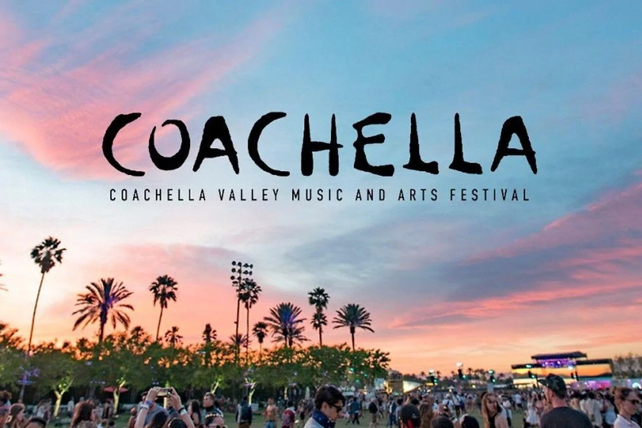 Crowd attending Coachella Valley Music and Arts Festival during sunset with palm trees and stage in the background.
