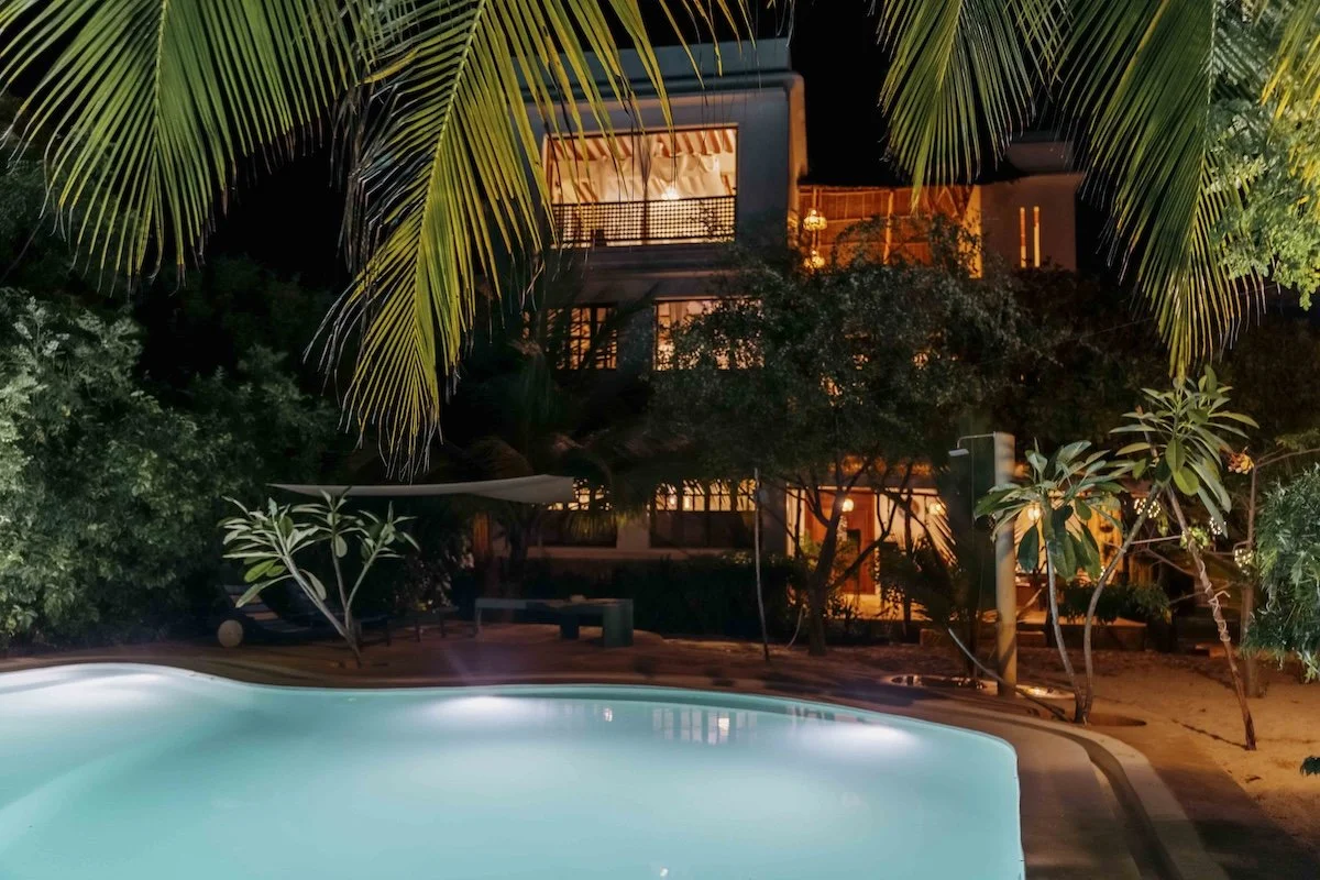 A shot of Mbibo House from the pool taken at night