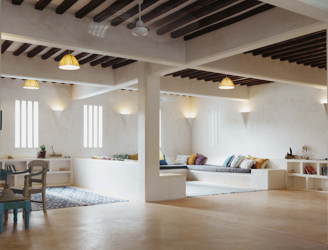 A light, open and airy living space with comfortable sofas and desk.