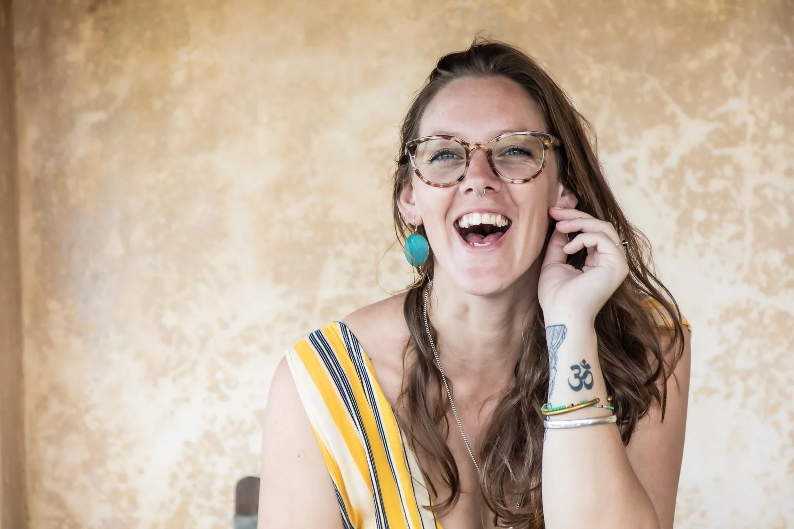 A picture of the host Hannah looking directly to camera and smiling wide