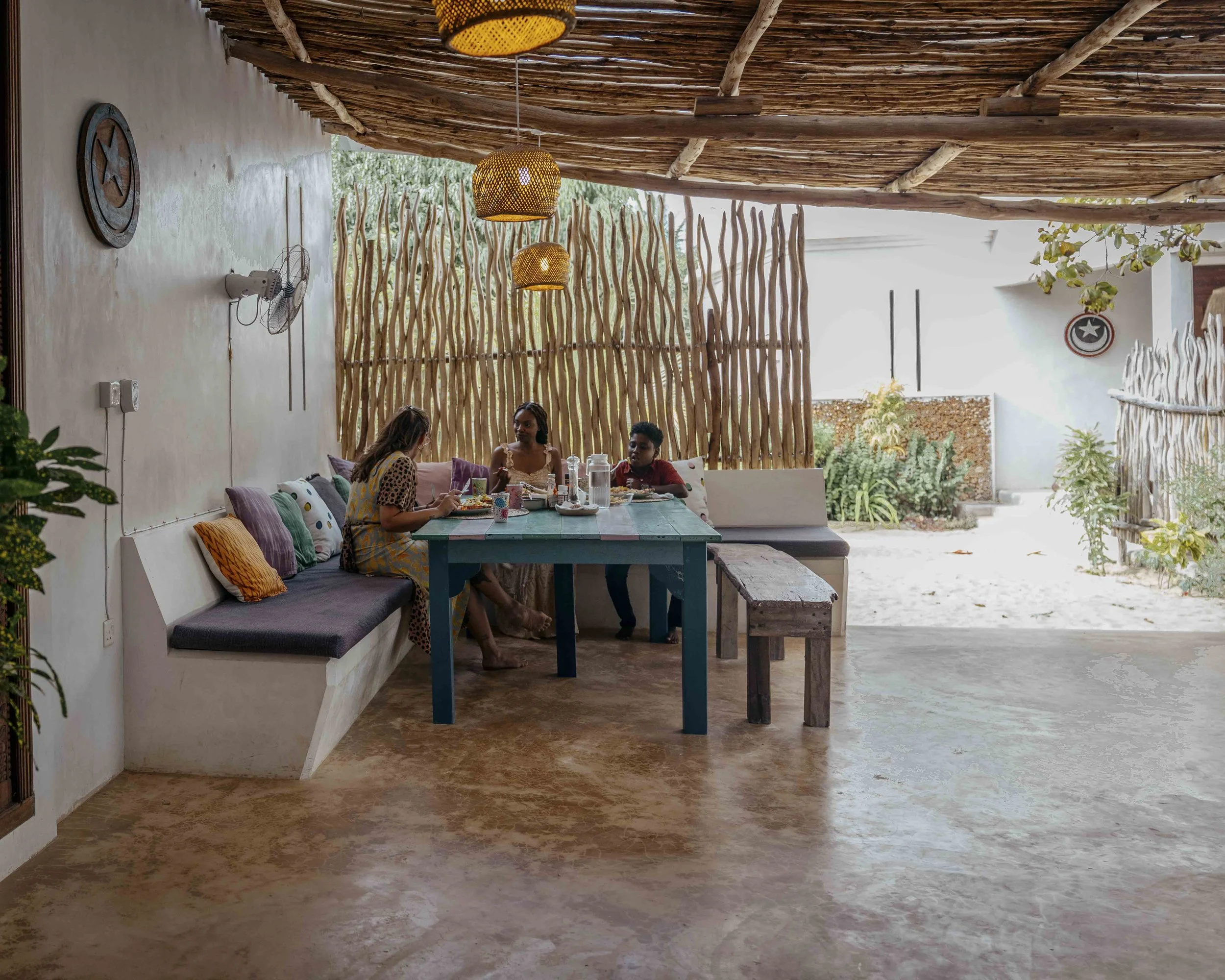 Our ground floor terrace with built in benches, a dining table and bench in natural tones.