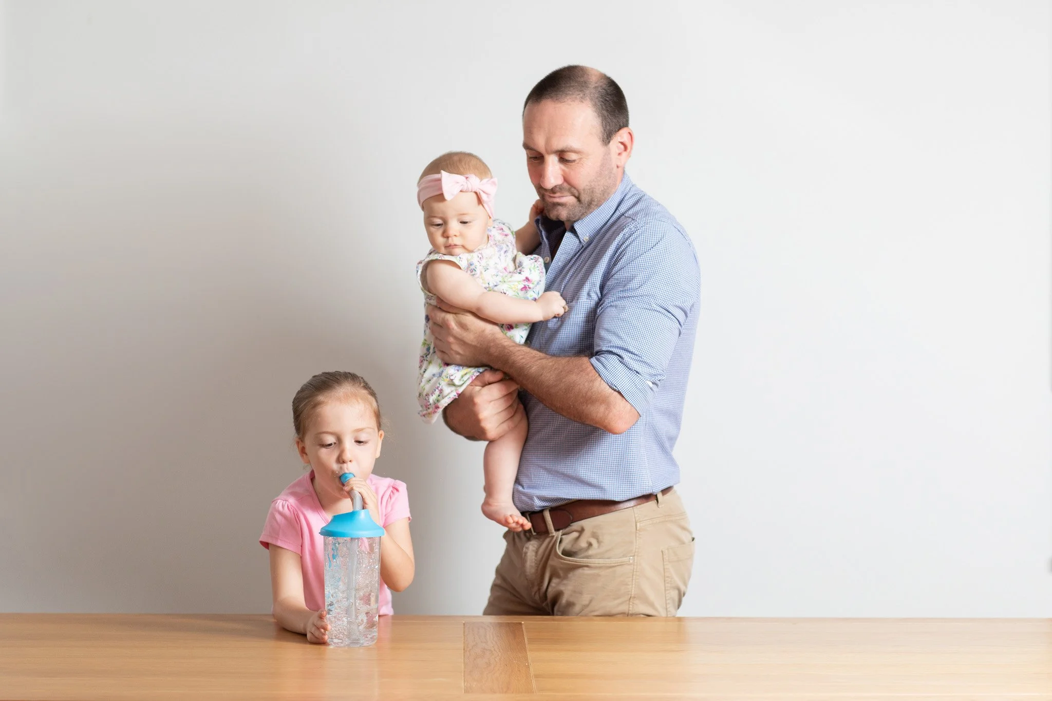 A young girl uses Hydrapep Bubble PEP while her family watches