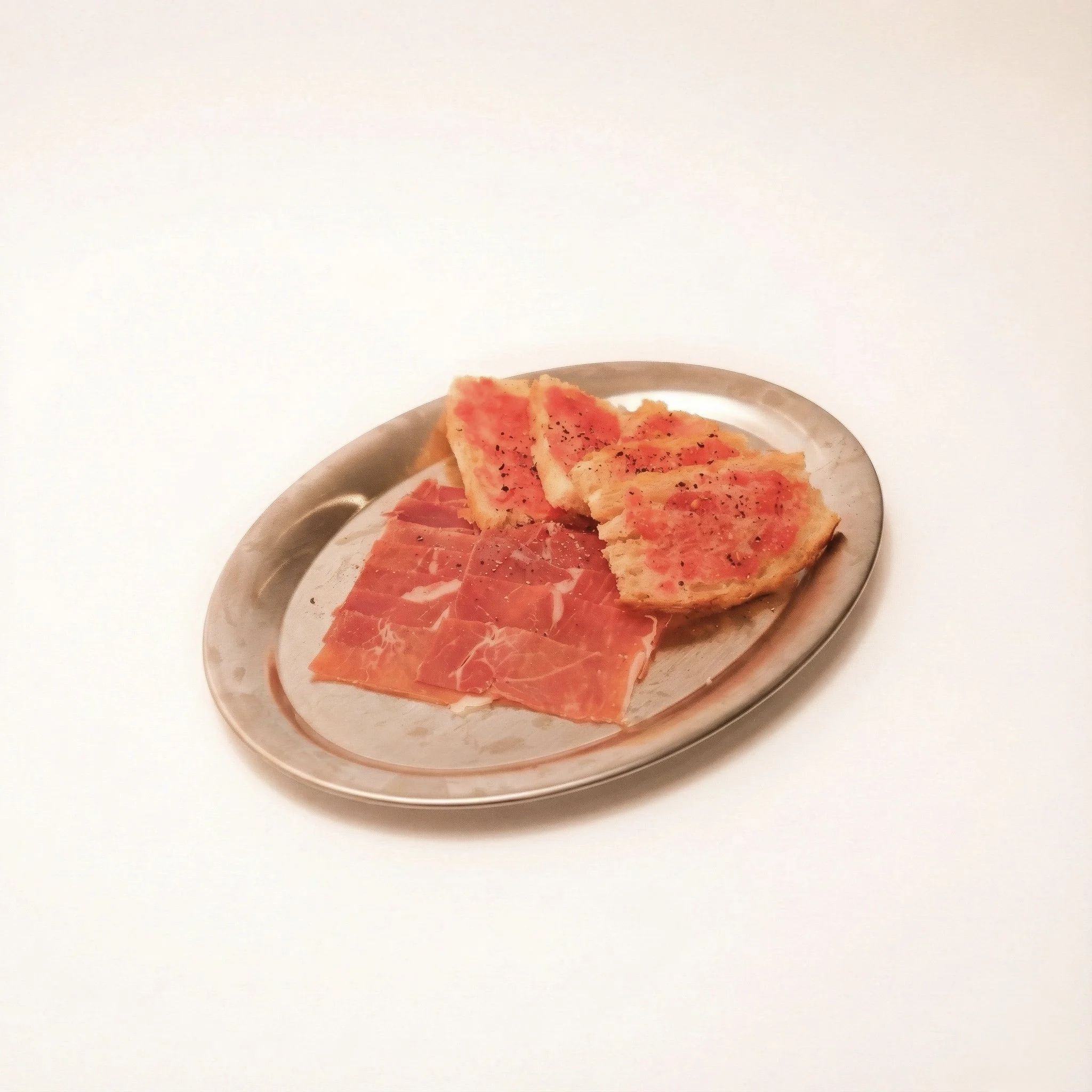 JAMÓN IBÉRICO WITH PAN CON TOMATE · Toasted bread topped with crushed tomato and thin jamón · 390