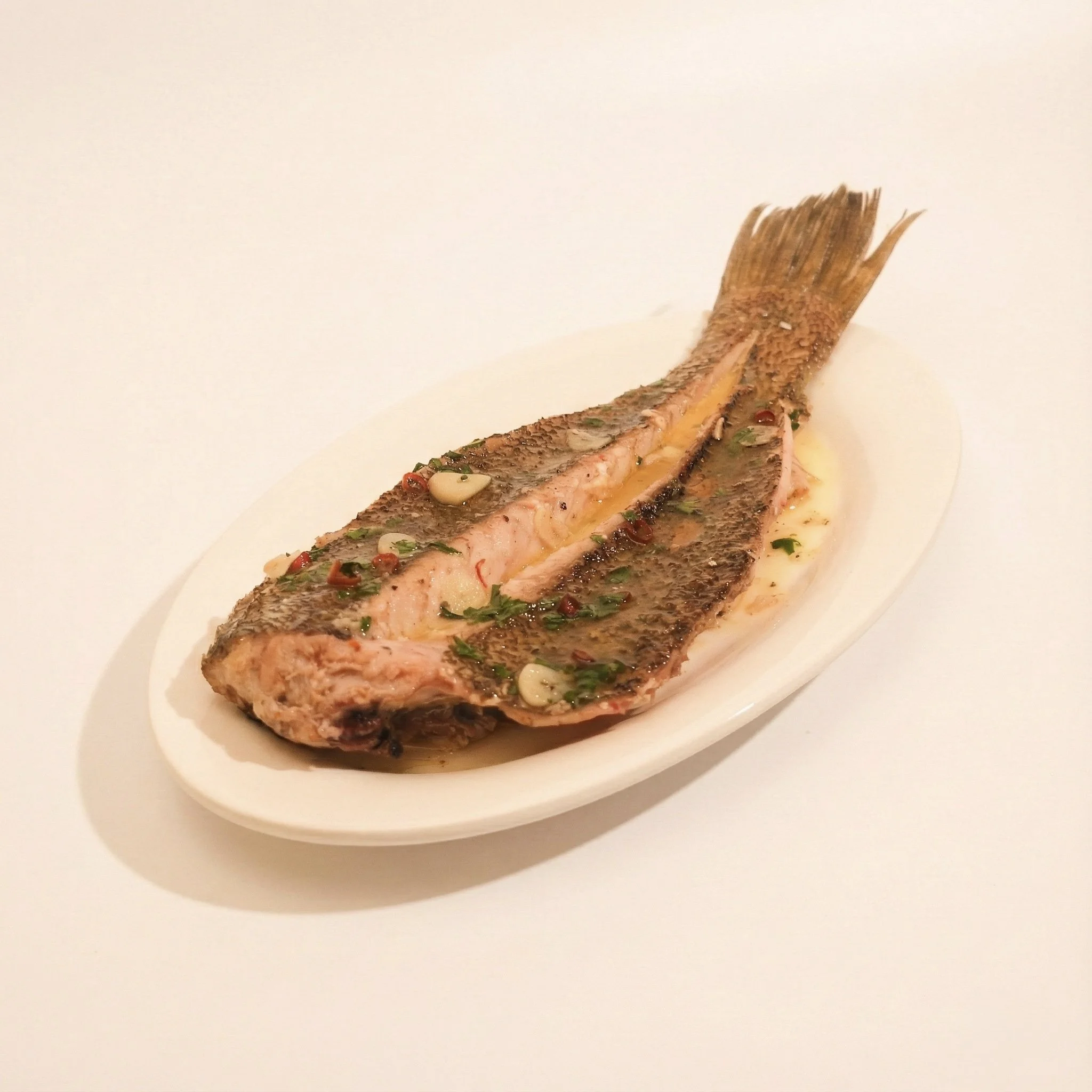 GRILLED HALIBUT · Charcoal grilled halibut tossed and finished in a paprika beurre blanc sauce · 720