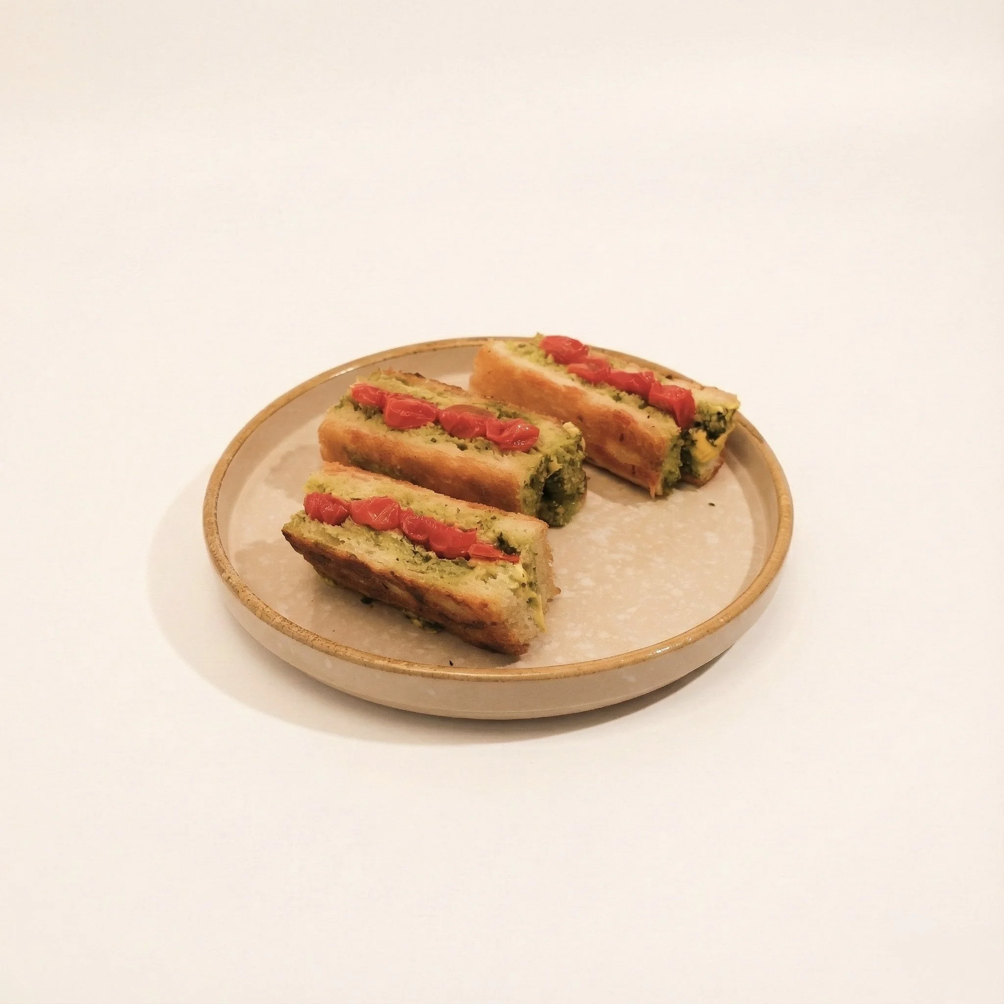 SUNDRIED TOMATO PESTO BIKINIS · Tomato, basil pesto, and cheese in a toasted golden stack · 220