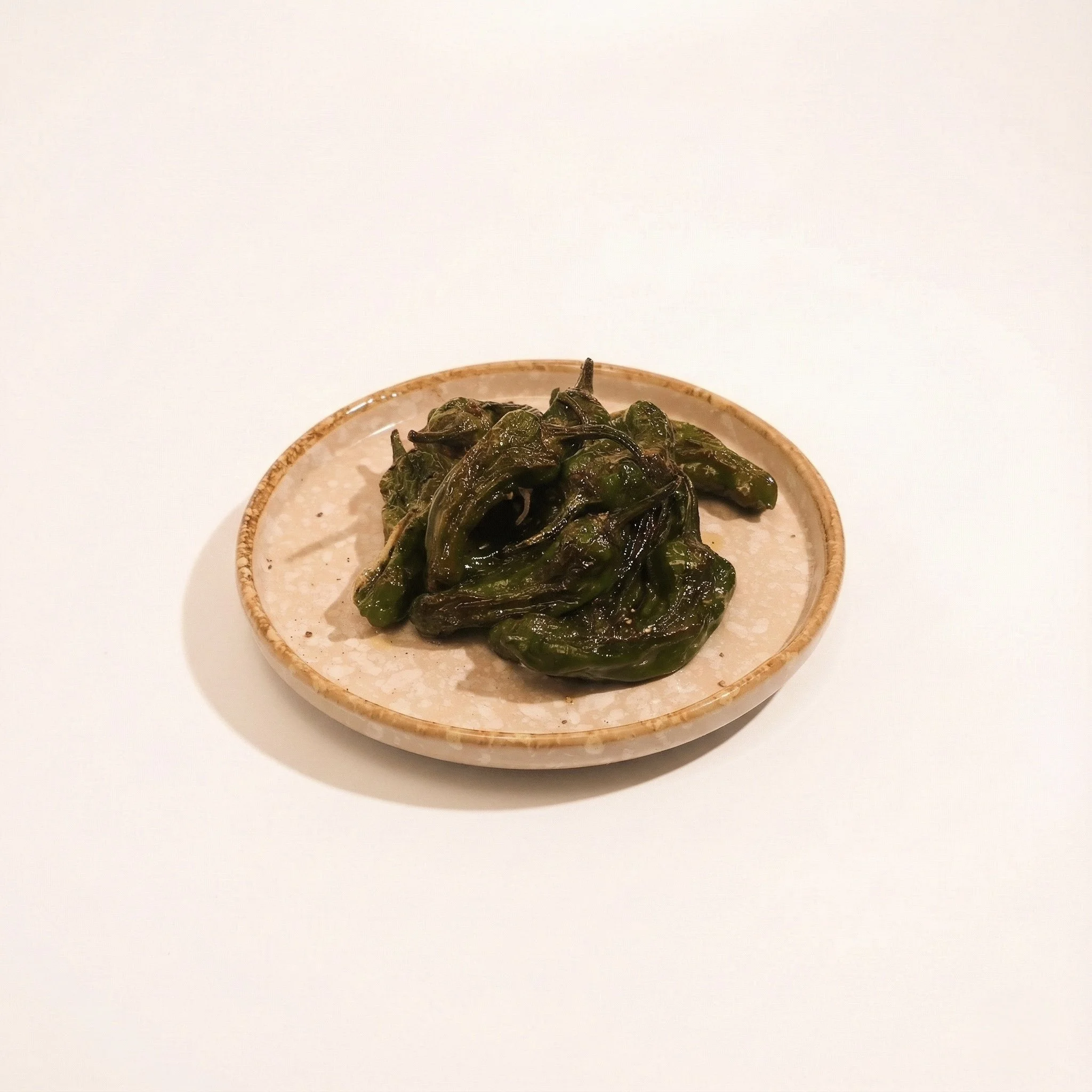PADRÓN PEPPERS · Charred peppers with flaky salt and a hint of heat · 290