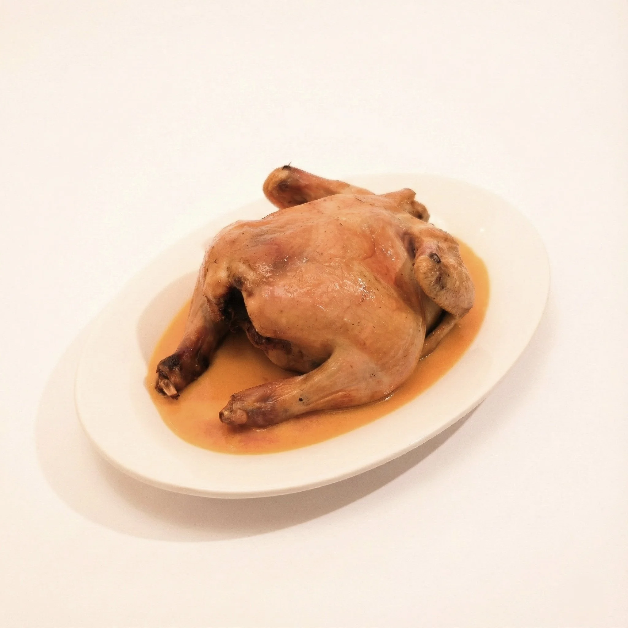 GRILLED BABY CHICKEN · Baby chicken grilled stuffed with root vegetables. Served with a siracha veloute · 780