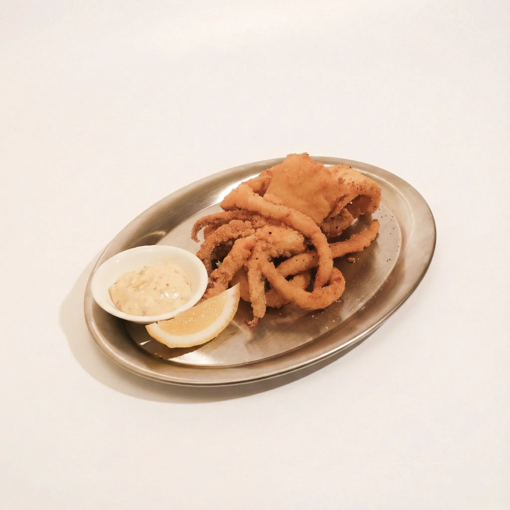 CALAMARI · Lightly fried squid slices served with a citrus aioli · 230