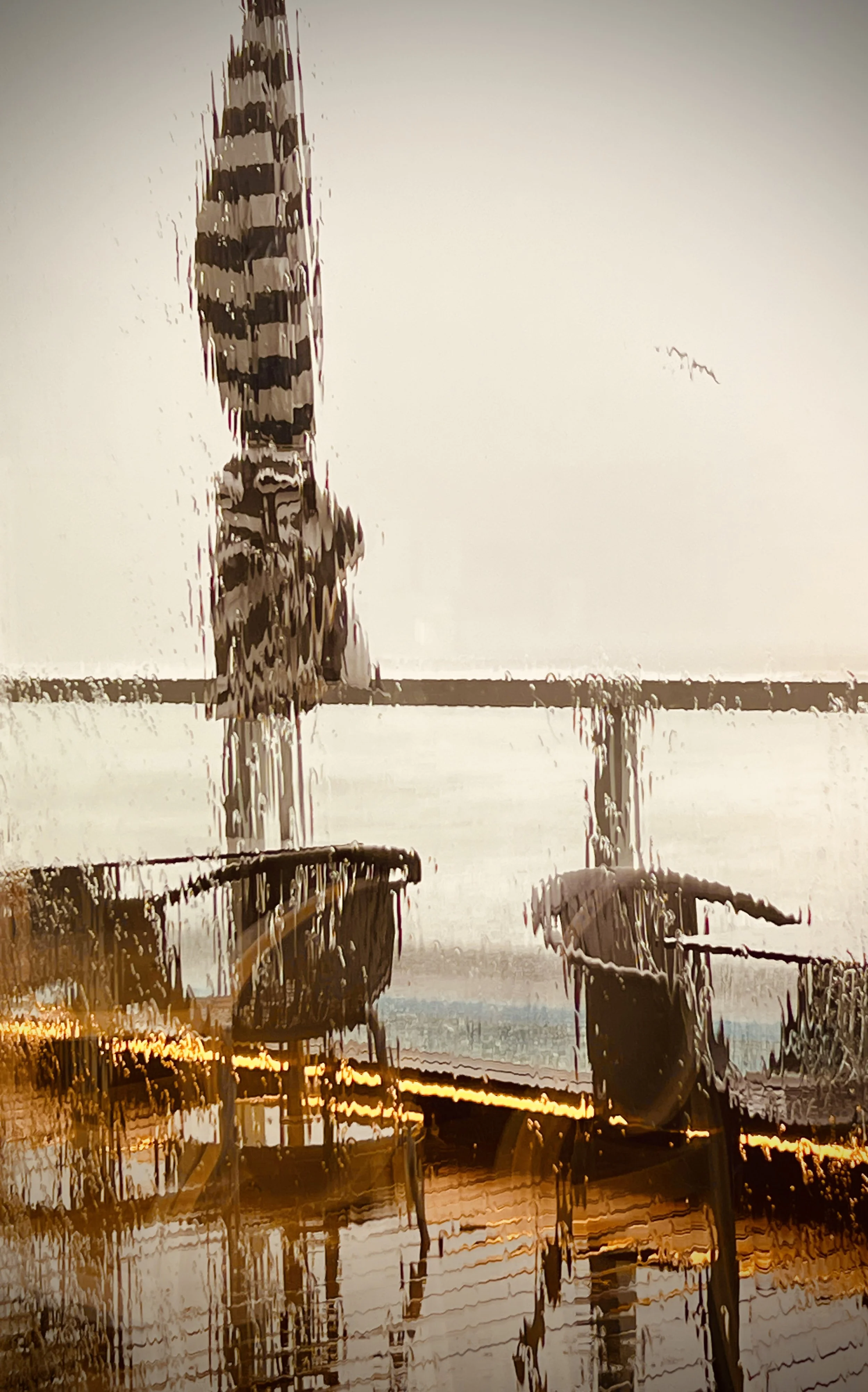 A distorted and blurry photograph of boats docked at a harbor.