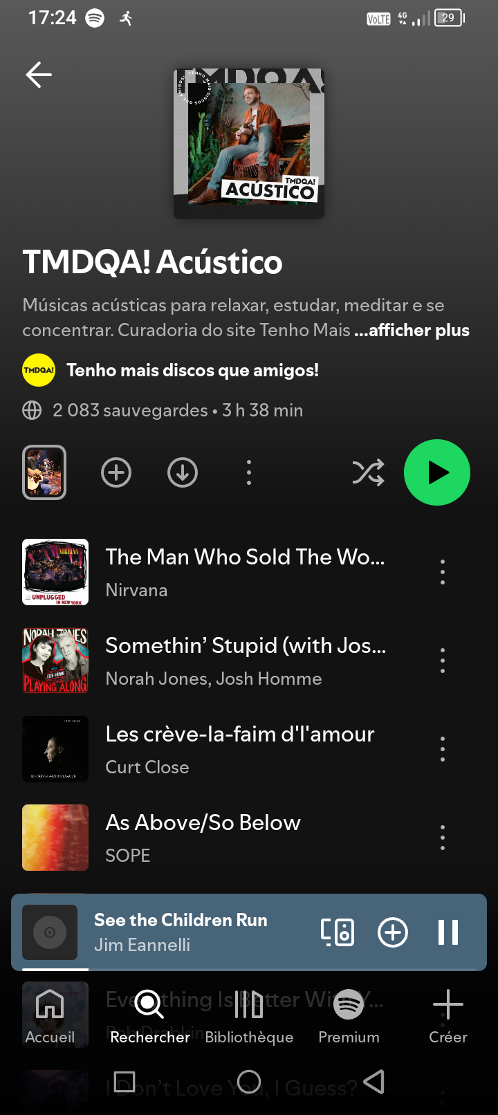Spotify app screen showing the album cover for TMDQA! Acústico, with a photo of a man sitting on a chair, playing guitar, surrounded by green plants. Playlist includes Nirvana, Norah Jones, Curt Close, and SOPE.