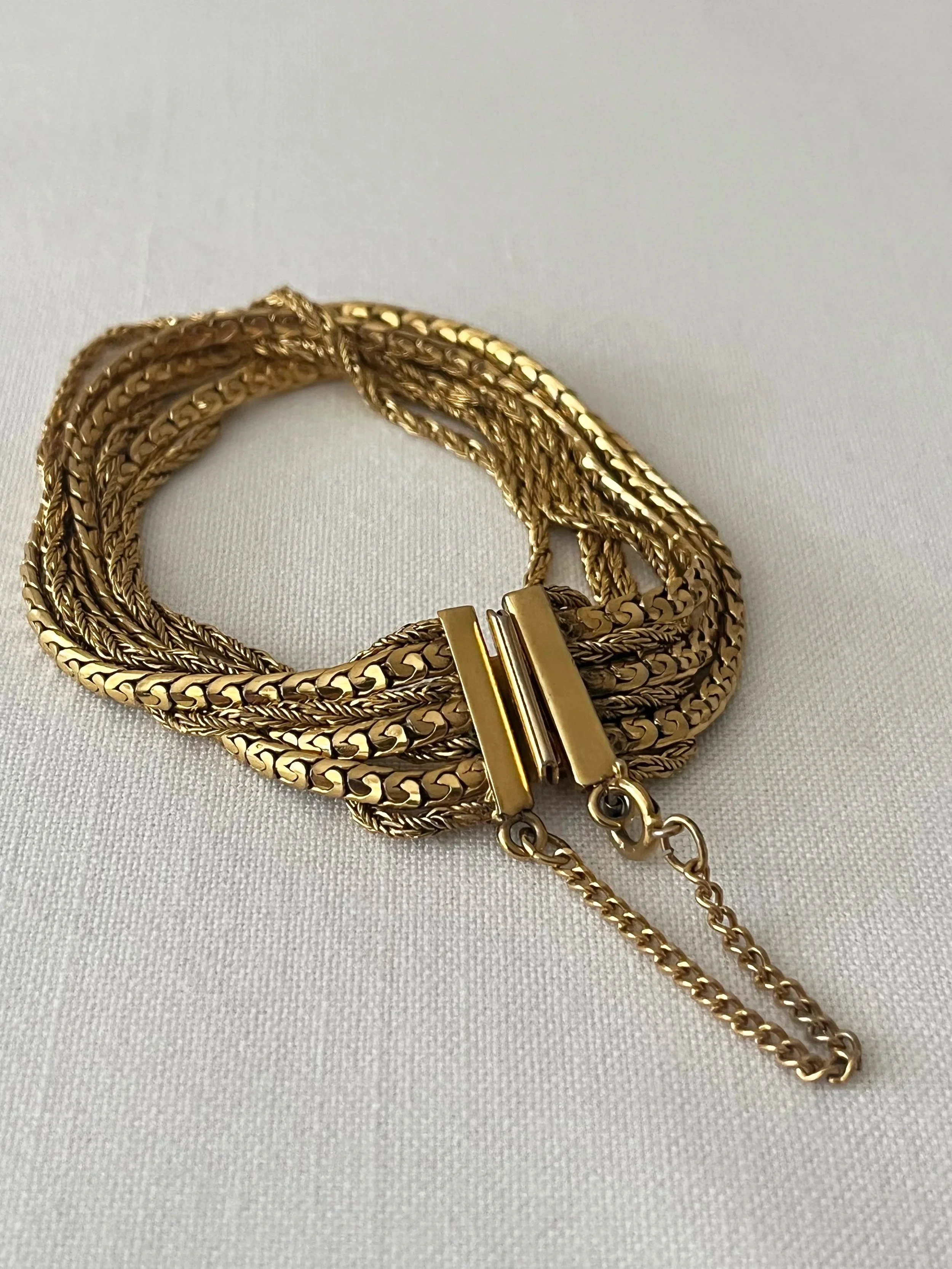 Gold textured multi strand bracelet with safety chain clasp fastening, 1970s costume jewellery