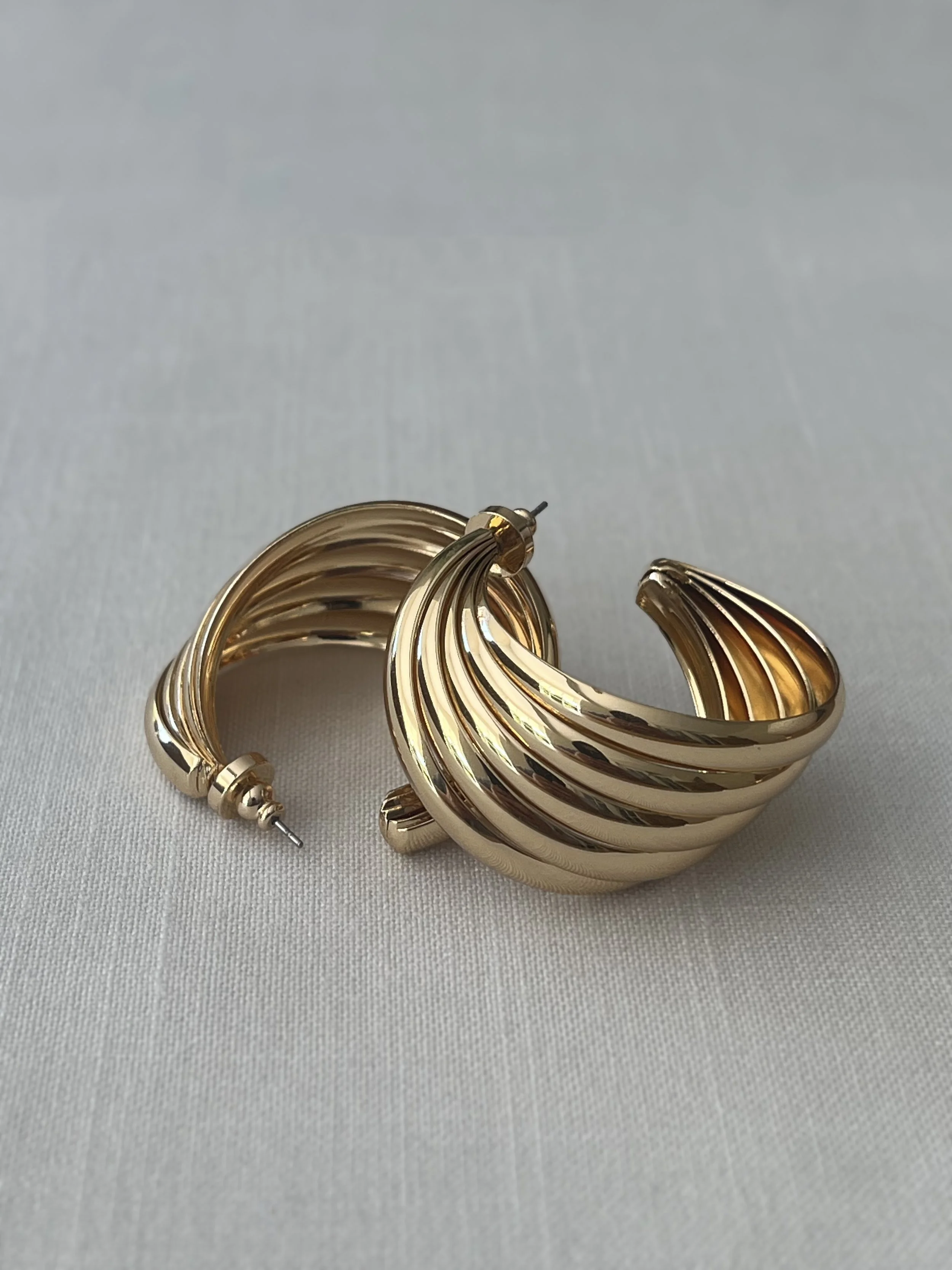 1980s GOLD RIBBED SWIRLED HALF-HOOP EARRINGS STACKED.jpg