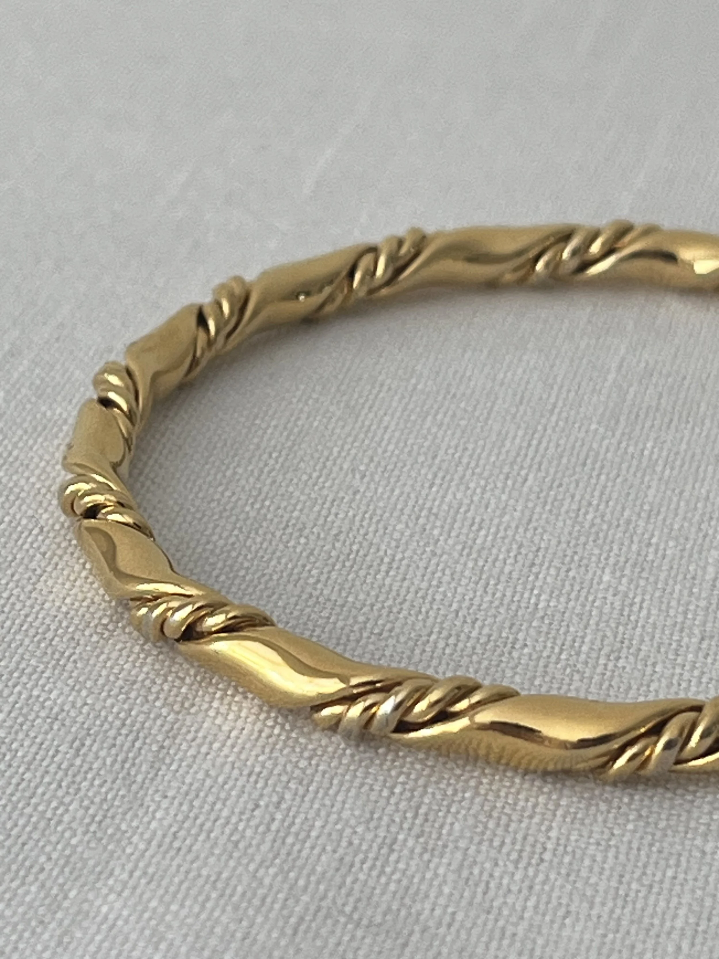 1980s MONET ROPE TWISTED GOLD BANGLE CLOSE UP.jpg