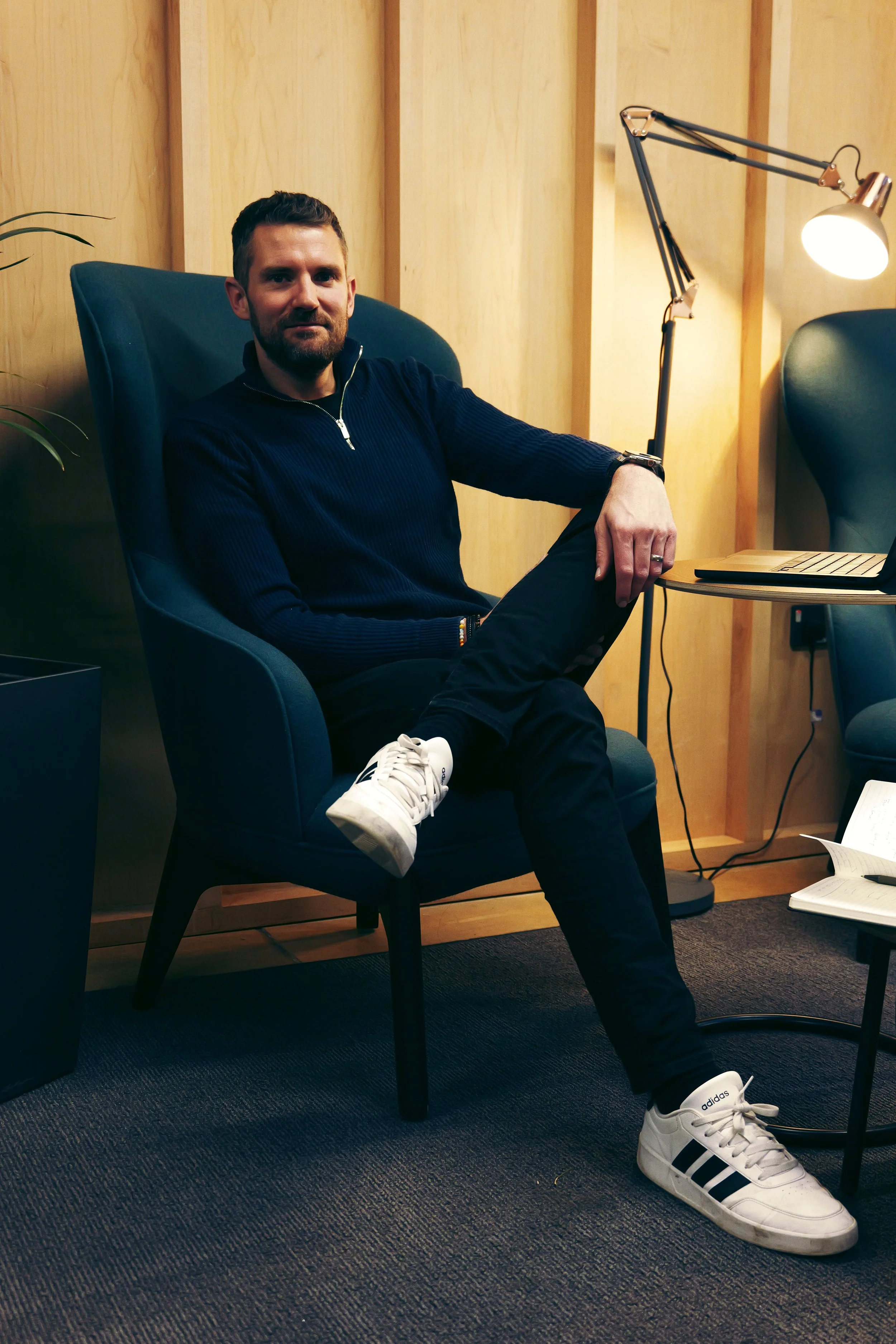 Senior healthcare and digital health consultant seated in a professional meeting space, providing strategic and operational advisory support