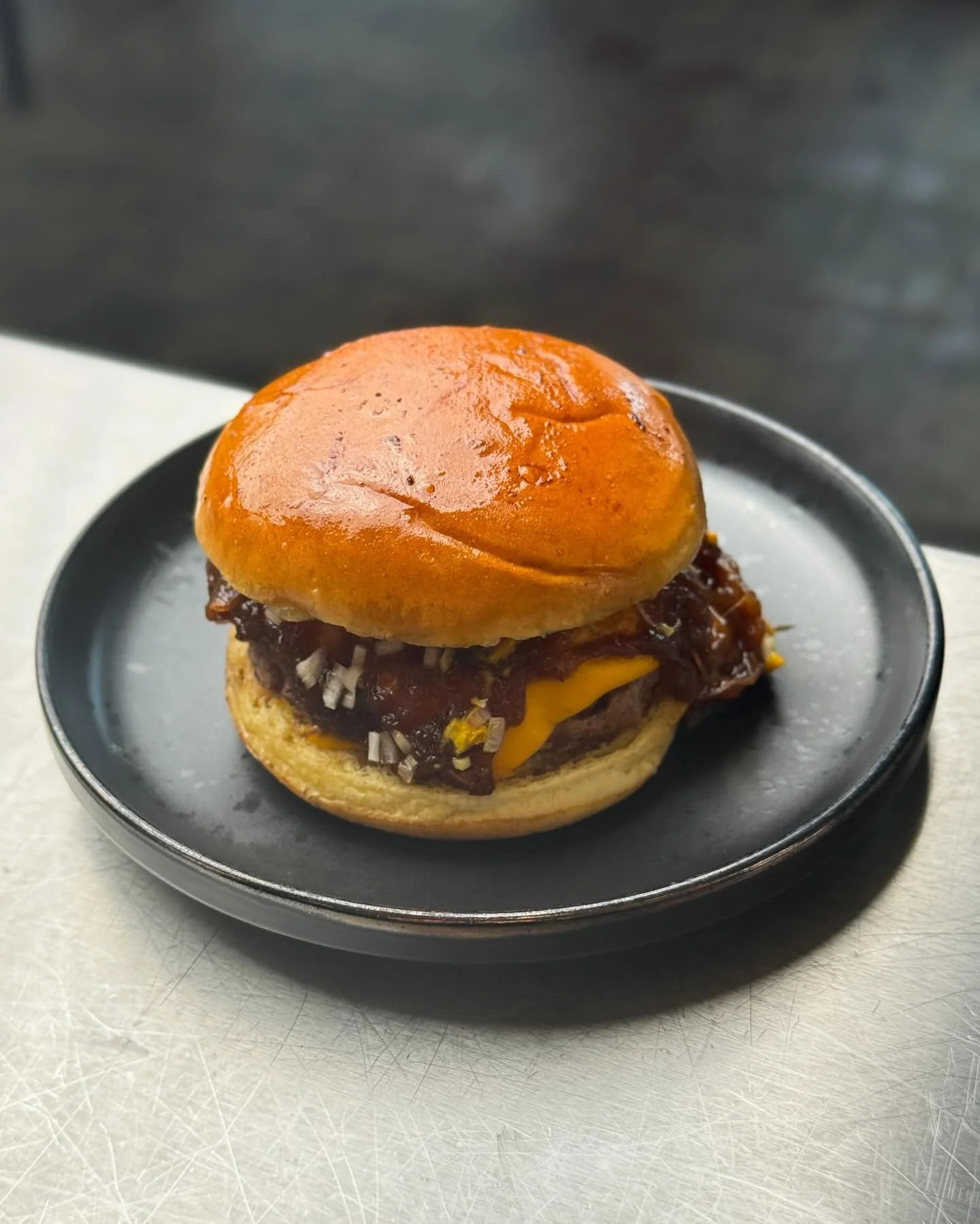 UMAMI BURGER

150g Aged beef patty cooked in miso butter and served rare, a sweet soft bun, slow cooked dashi onions, burger cheese, raw shallots, American mustard and x4 slices of gherkin.

Lots of DM&rsquo;s asking to keep it on for the final week,