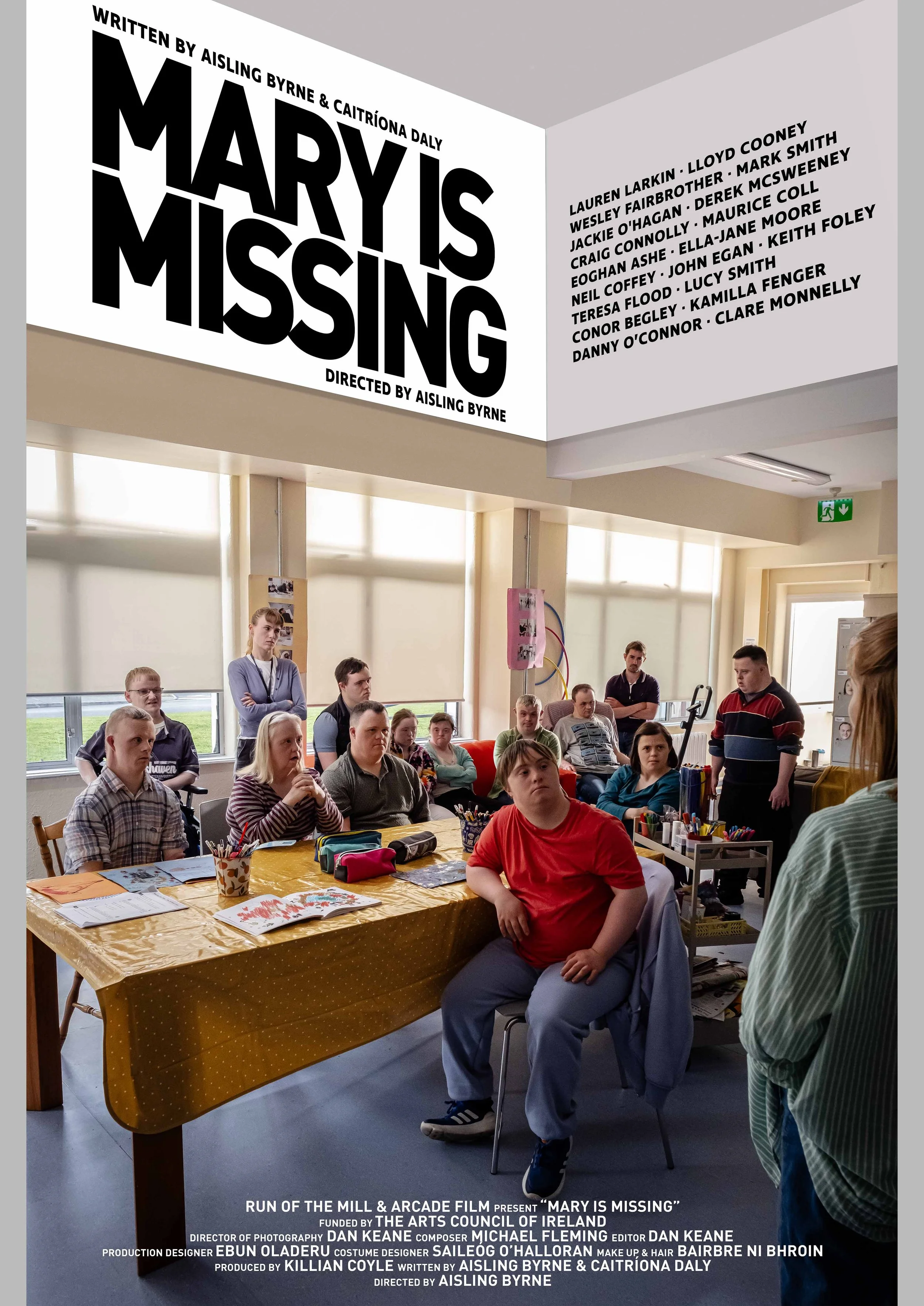 Poster for the production 'Mary is Missing' featuring a classroom scene with students seated at a table and others standing, with a woman speaking in front of them. The poster includes cast and crew information and a large title at the top.