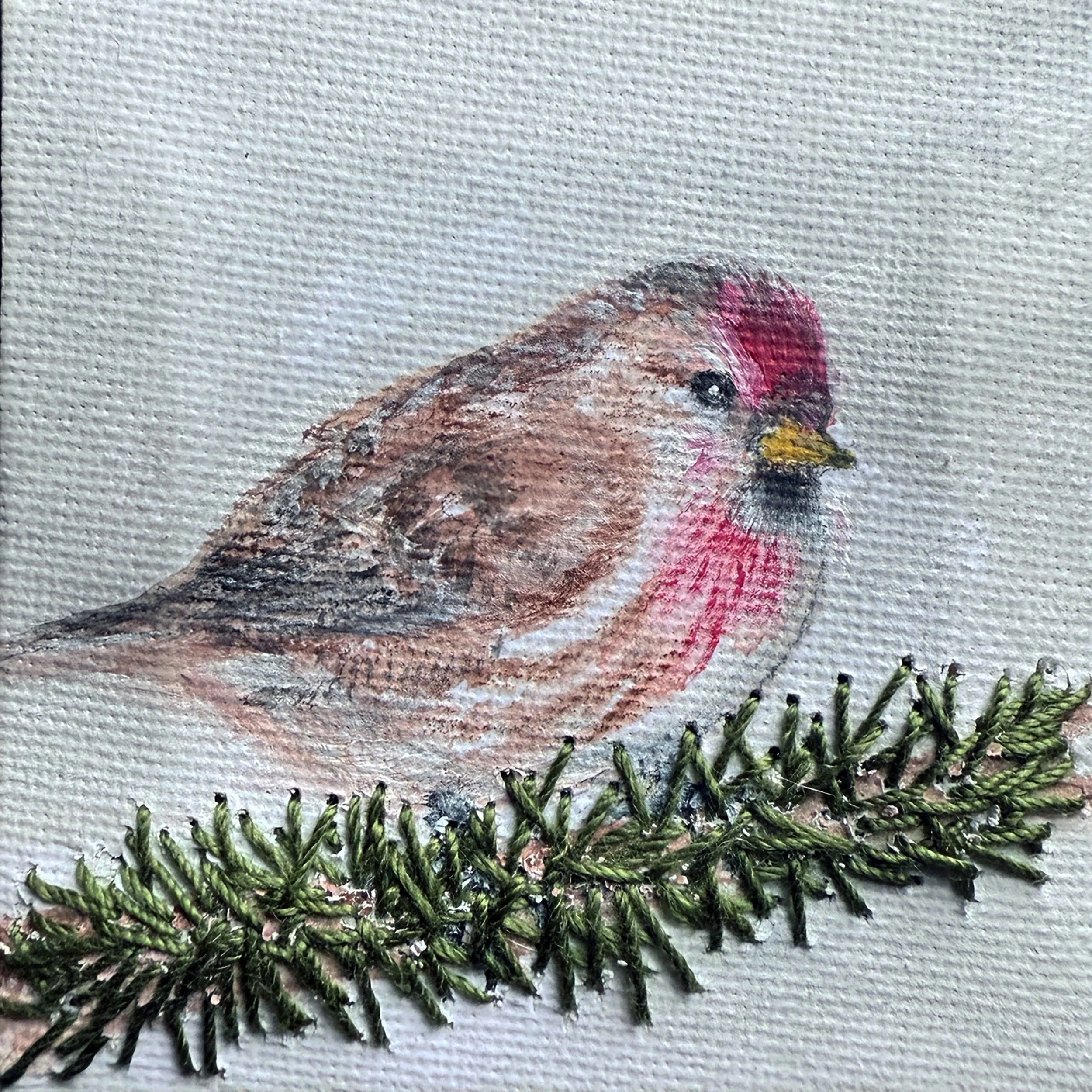 Redpoll on embroidered branch